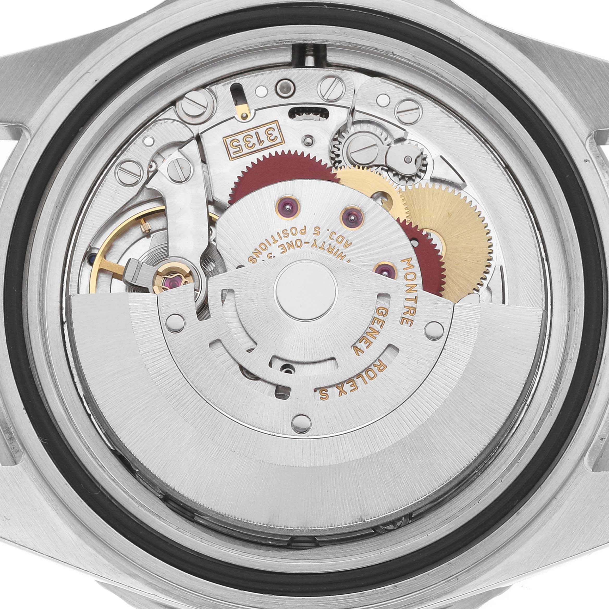 The image shows the movement of a Rolex Submariner 16610 Men
s Stainless Steel Black Dial watch from a top-down angle, revealing its inner mechanical parts.