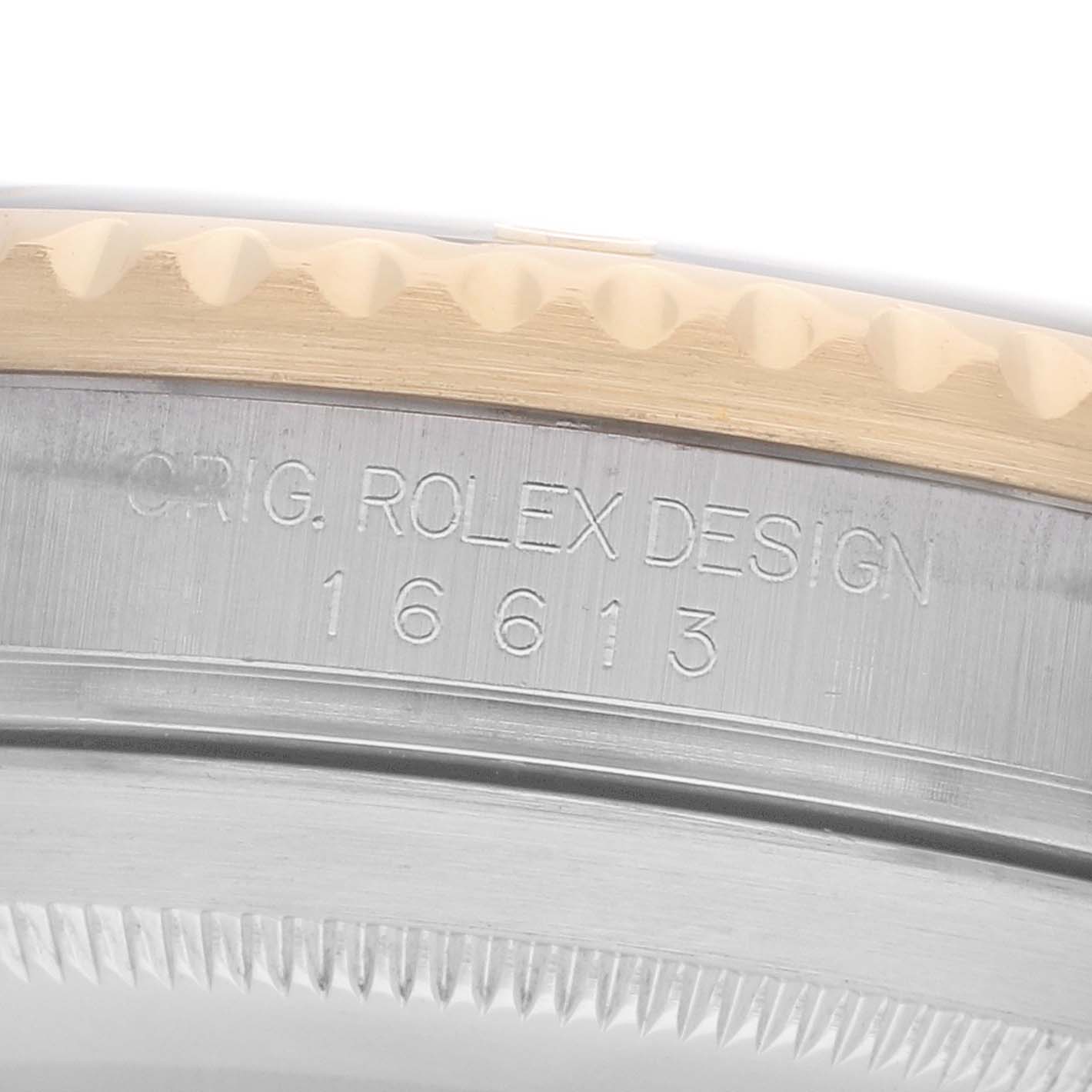 The image shows a close-up of the side of a Rolex Submariner 16613 Men
s Steel and Gold (two tone) Black Dial, highlighting the watch model number "16613" engraved on the case.