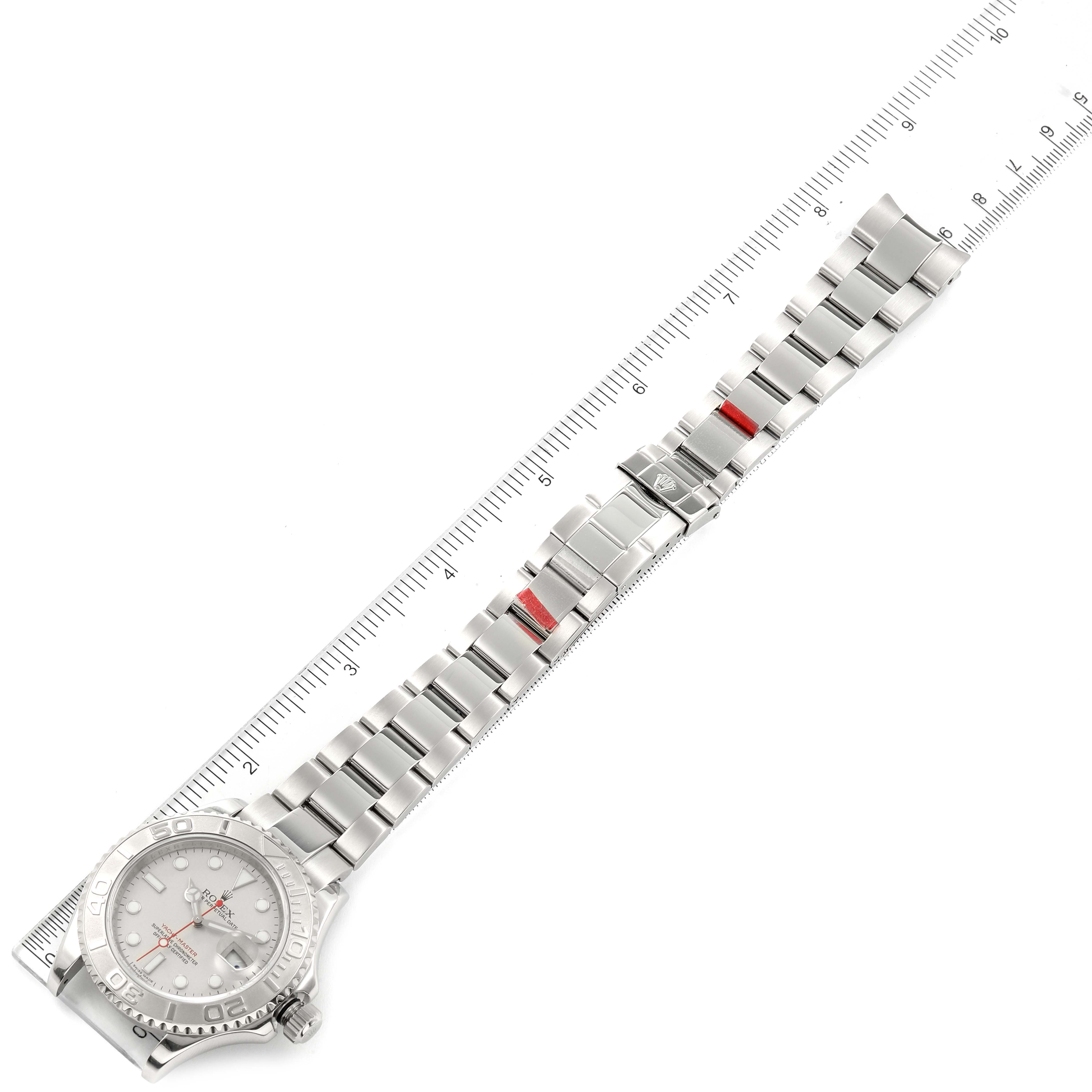 This image depicts a Rolex Yacht-Master 16622 Men
s Stainless Steel Silver Dial 16622 Men
s Stainless Steel Silver Dial watch viewed from above, showing the full bracelet and clasp beside a ruler for scale.