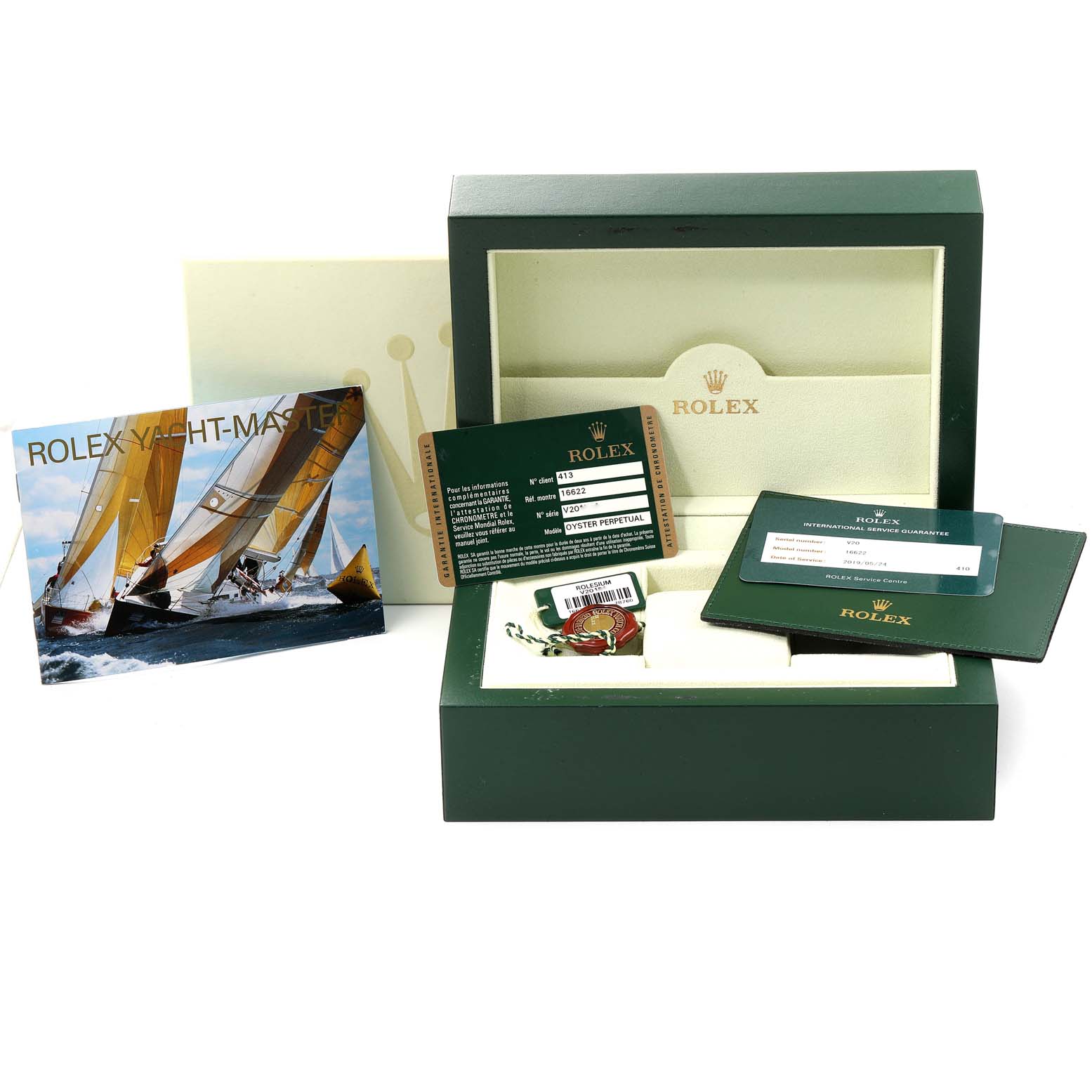 The image shows a Rolex Yacht-Master 16622 Men
s Stainless Steel Silver Dial 16622 Men
s Stainless Steel Silver Dial box set with warranty card, tags, and booklet from a front angle.