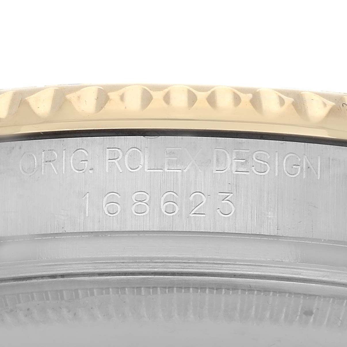 The image shows a close-up of the side of a Rolex Yacht-Master 168623 Men
s Steel and Gold (two tone) White Dial case, including the engraved model number.