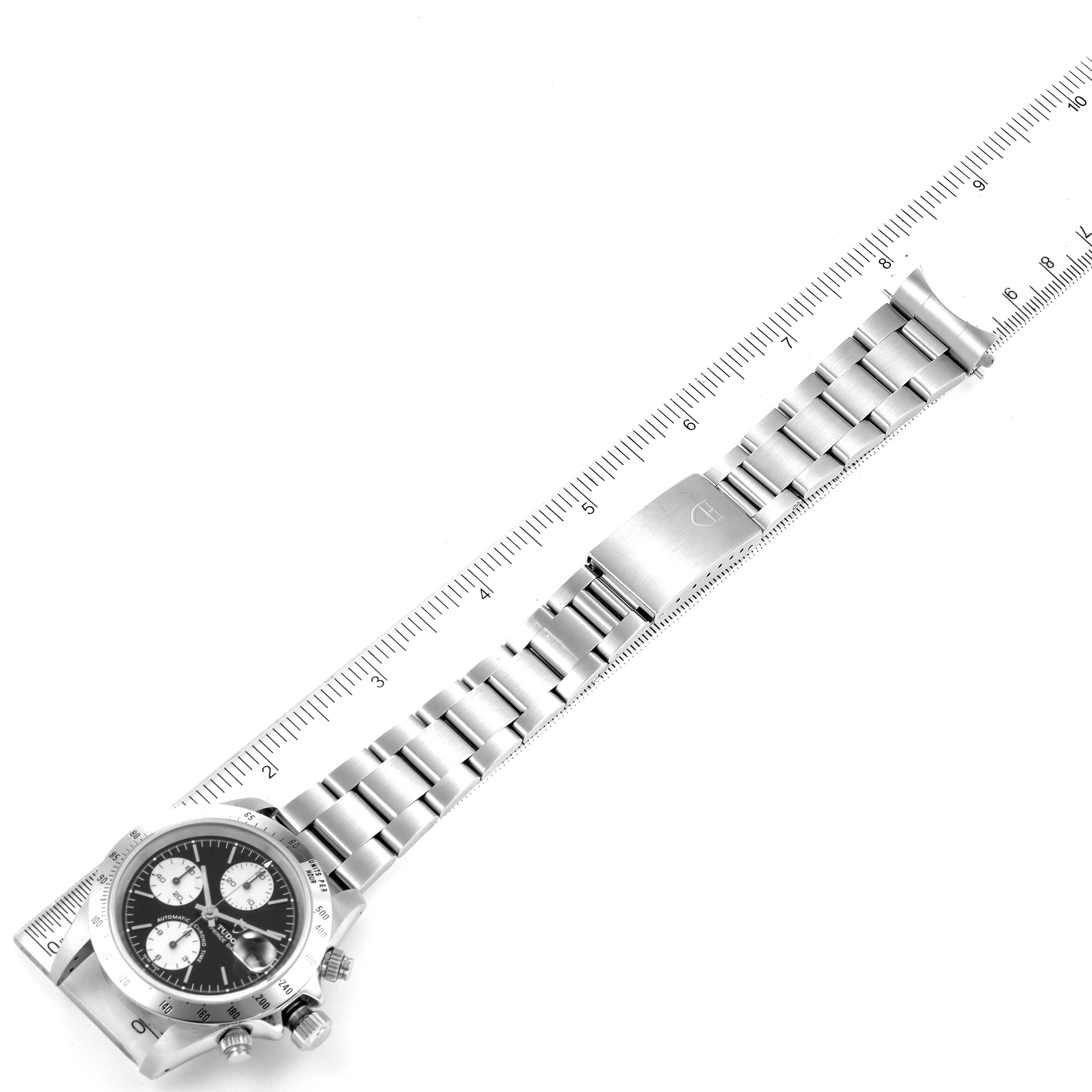 The image shows a Tudor Prince 79280 Men
s Stainless Steel Black Dial 79280 Men
s Stainless Steel Black Dial watch laid flat with an attached ruler measuring its metal bracelet and clasp.