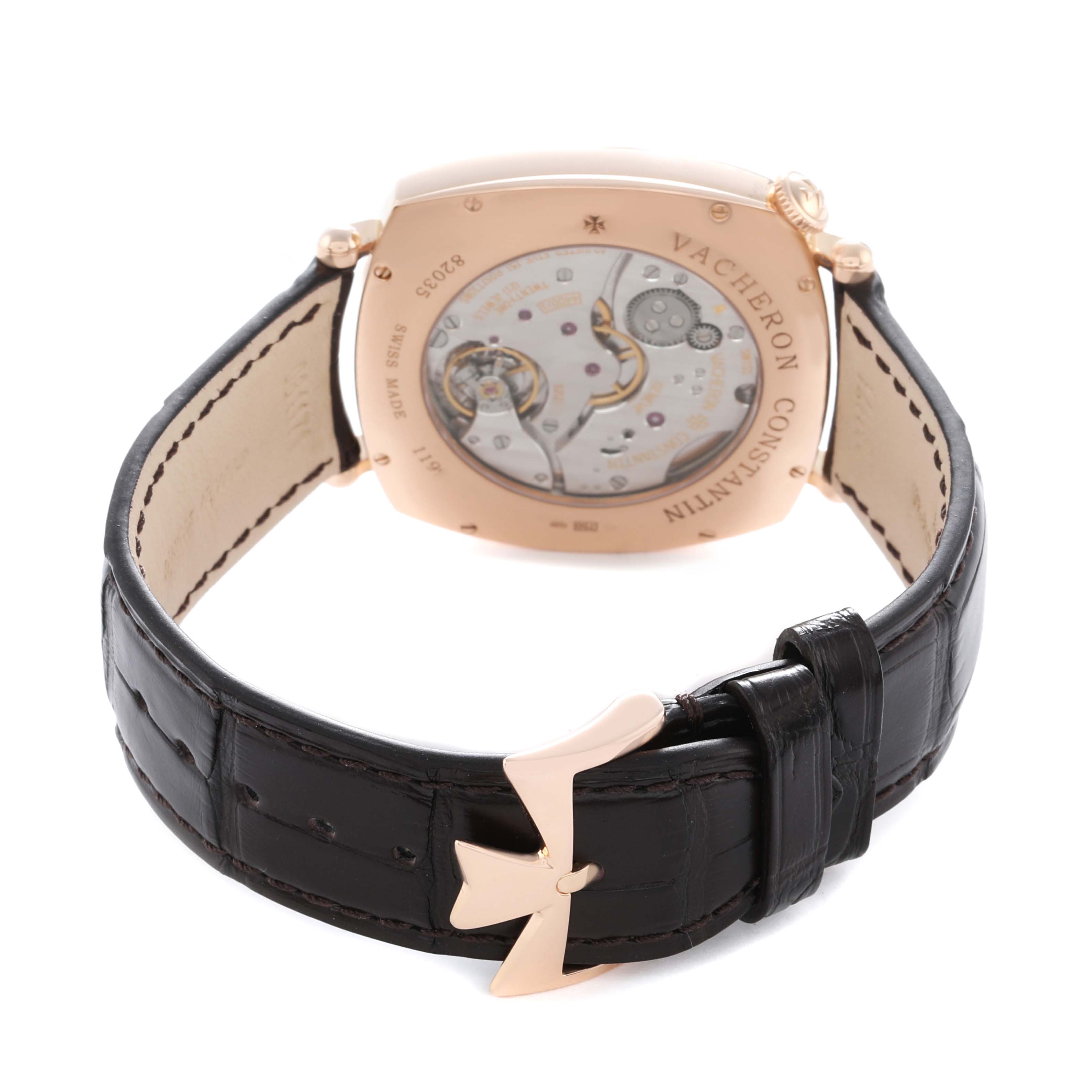 The Vacheron Constantin Historiques 82035 Men
s Rose Gold Silver Dial watch is shown from the back, highlighting the transparent case back and leather strap with clasp.