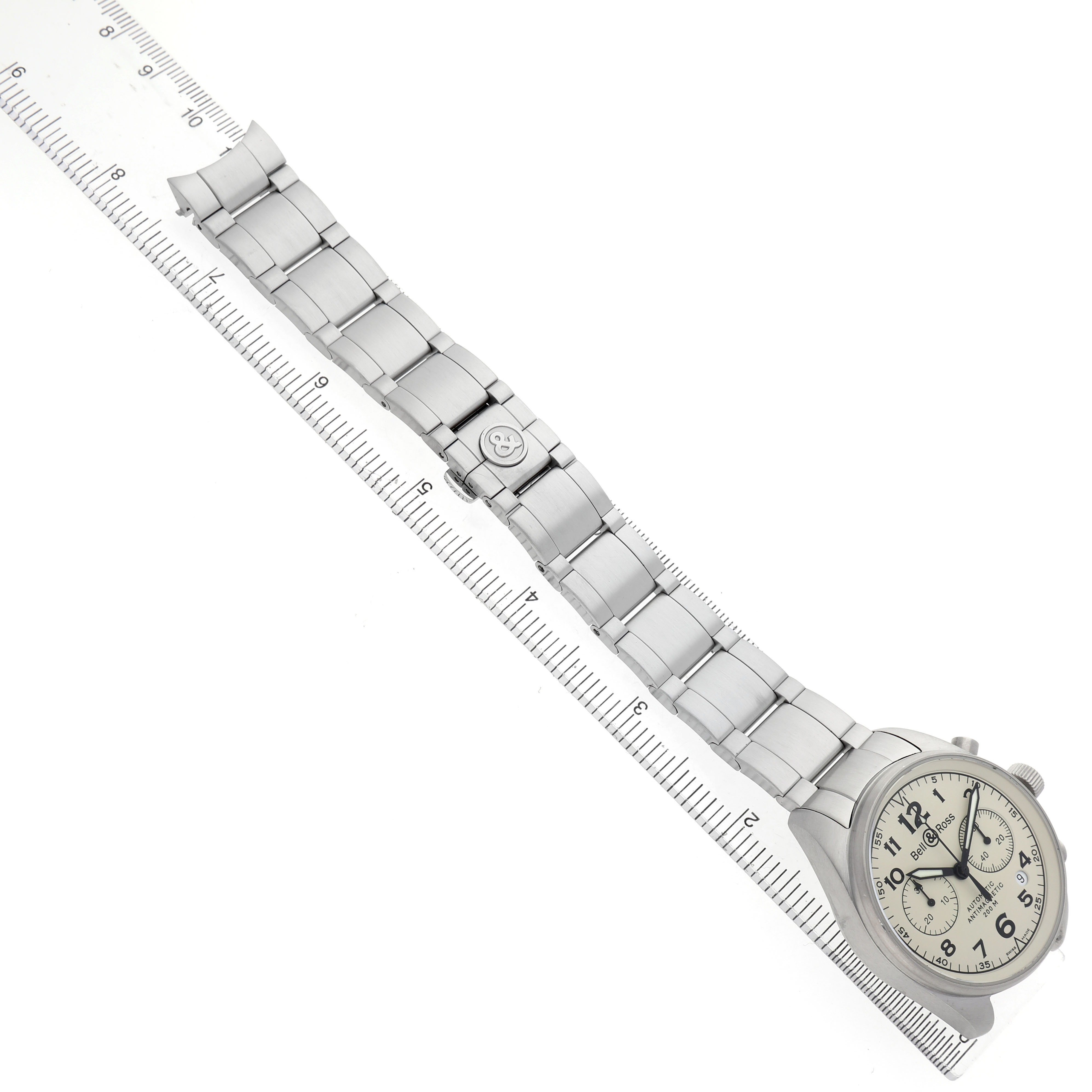 The Bell & Ross Vintage BRV126-BEI-ST Men's Stainless Steel Beige Dial model is shown from an overhead angle, displaying the full bracelet and dial against a ruler.