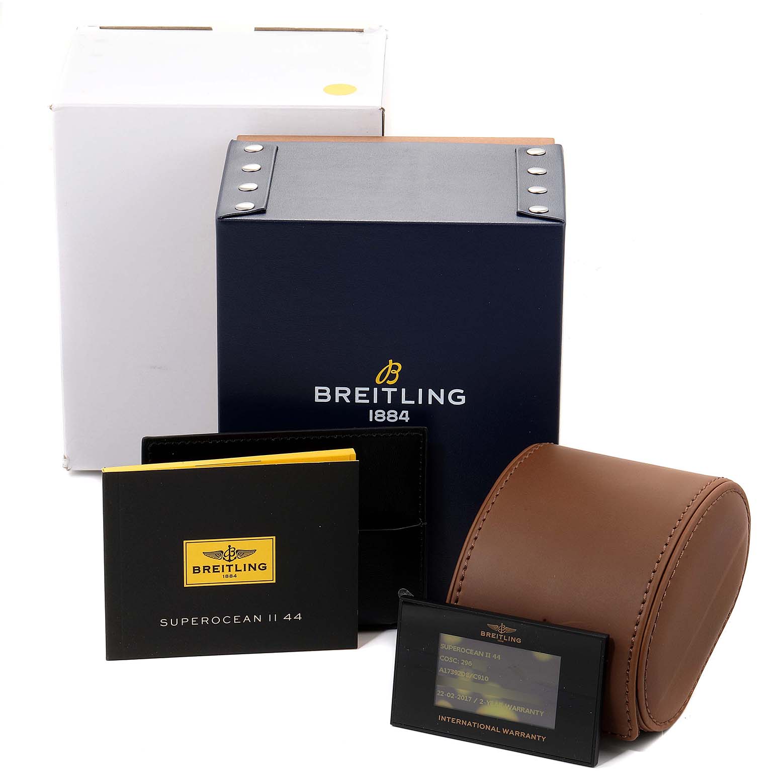 This image shows the packaging and accessories for a Breitling Superocean A17392 Men's Stainless Steel Blue Dial A17392 Men's Stainless Steel Blue Dial watch, including the box, warranty card, leather case, and manual.