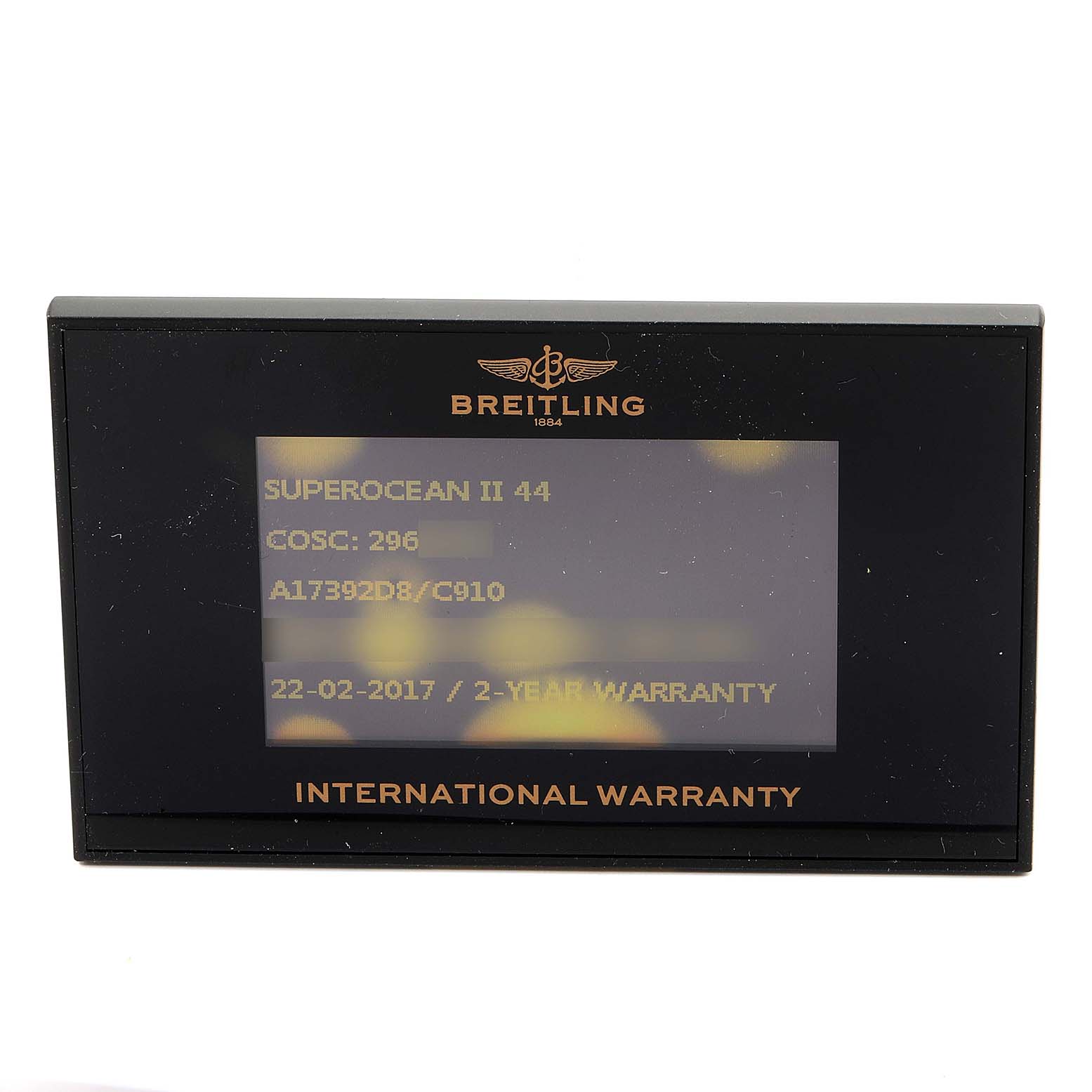 The image shows a Breitling Superocean A17392 Men's Stainless Steel Blue Dial A17392 Men's Stainless Steel Blue Dial warranty card with details like model, COSC number, and purchase date.