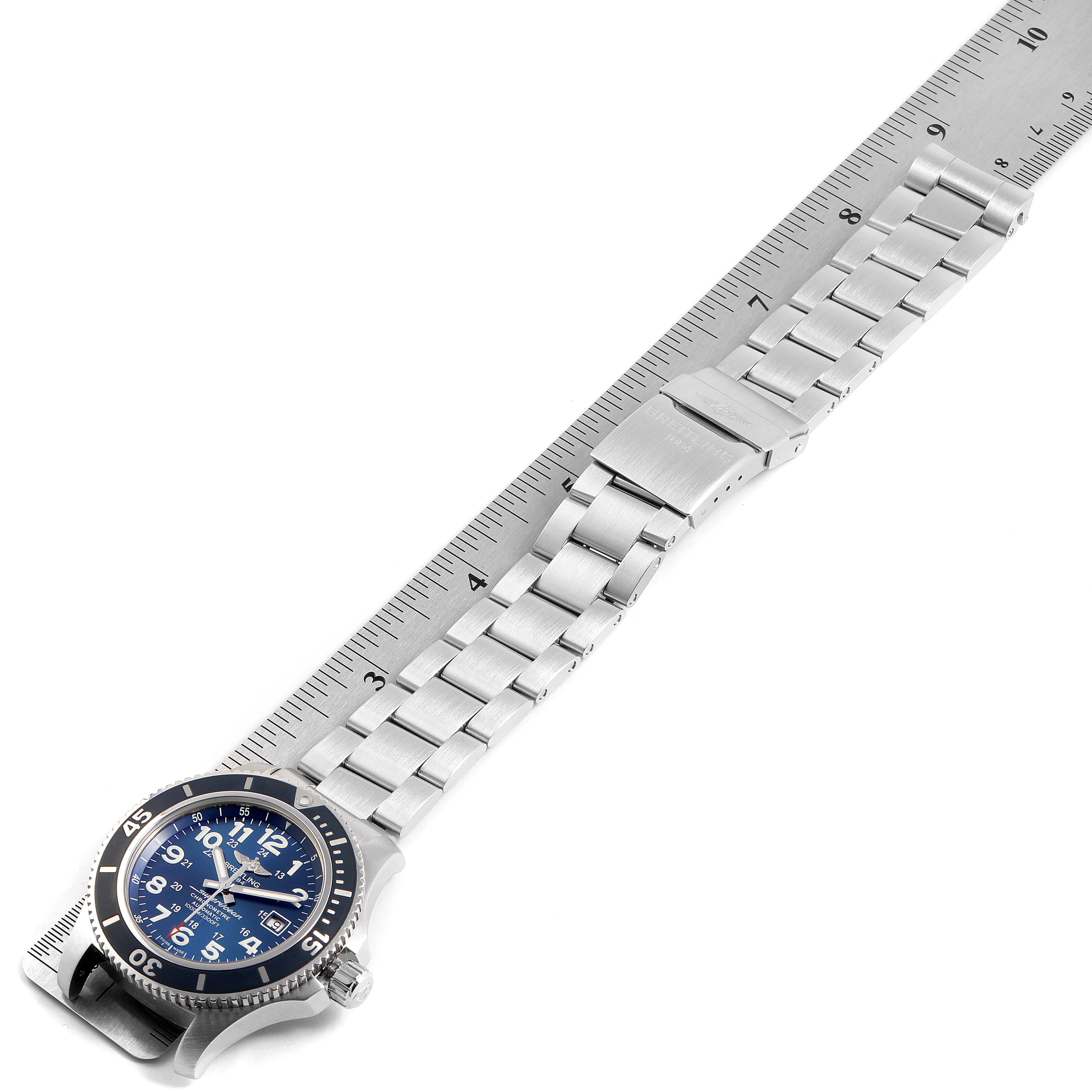 The image shows a side angle of the Breitling Superocean A17392 Men's Stainless Steel Blue Dial A17392 Men's Stainless Steel Blue Dial watch, highlighting its bracelet, clasp, and watch face placed against a ruler.