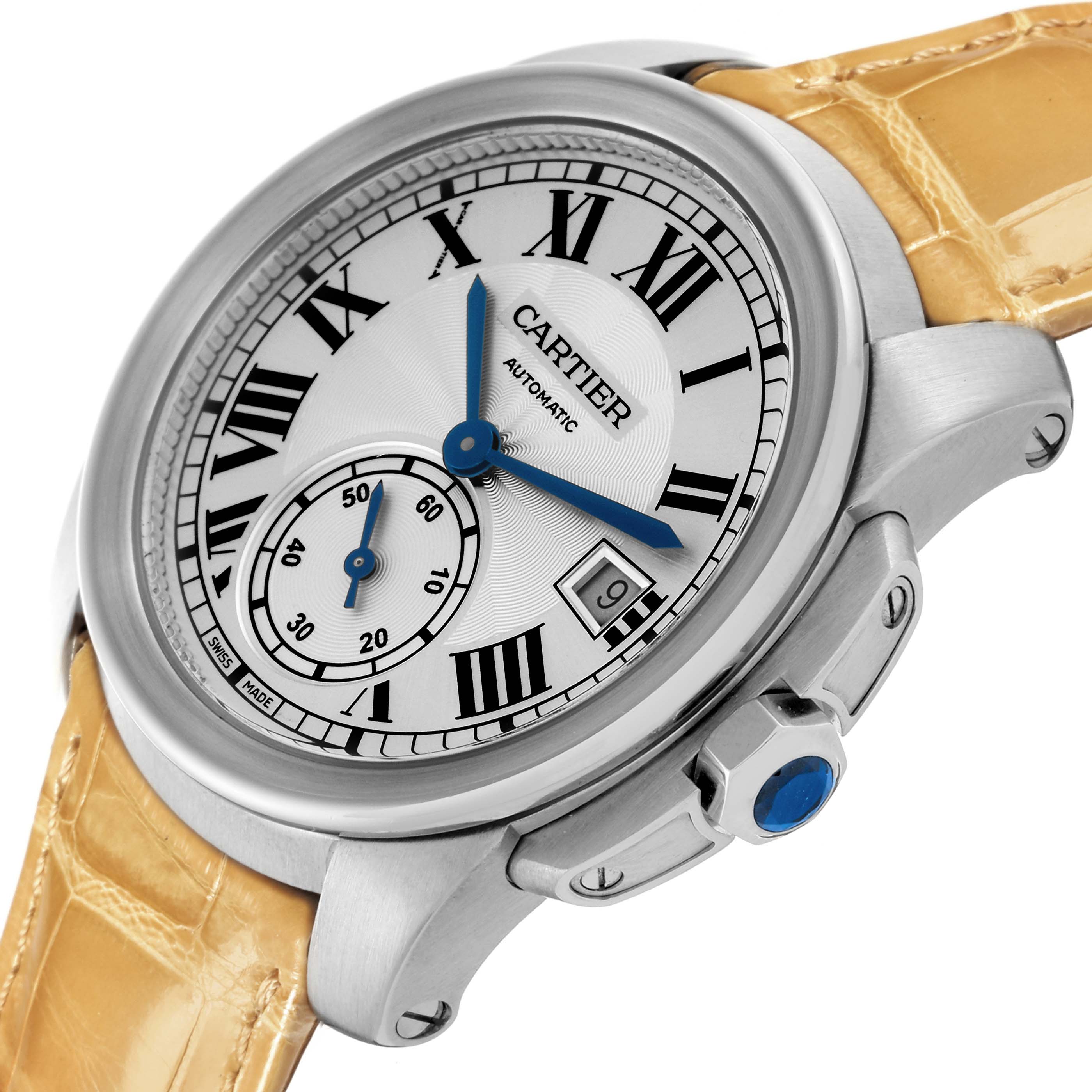 The Calibre de Cartier watch is shown at a slight angle, displaying the dial, bezel, crown, and leather strap.