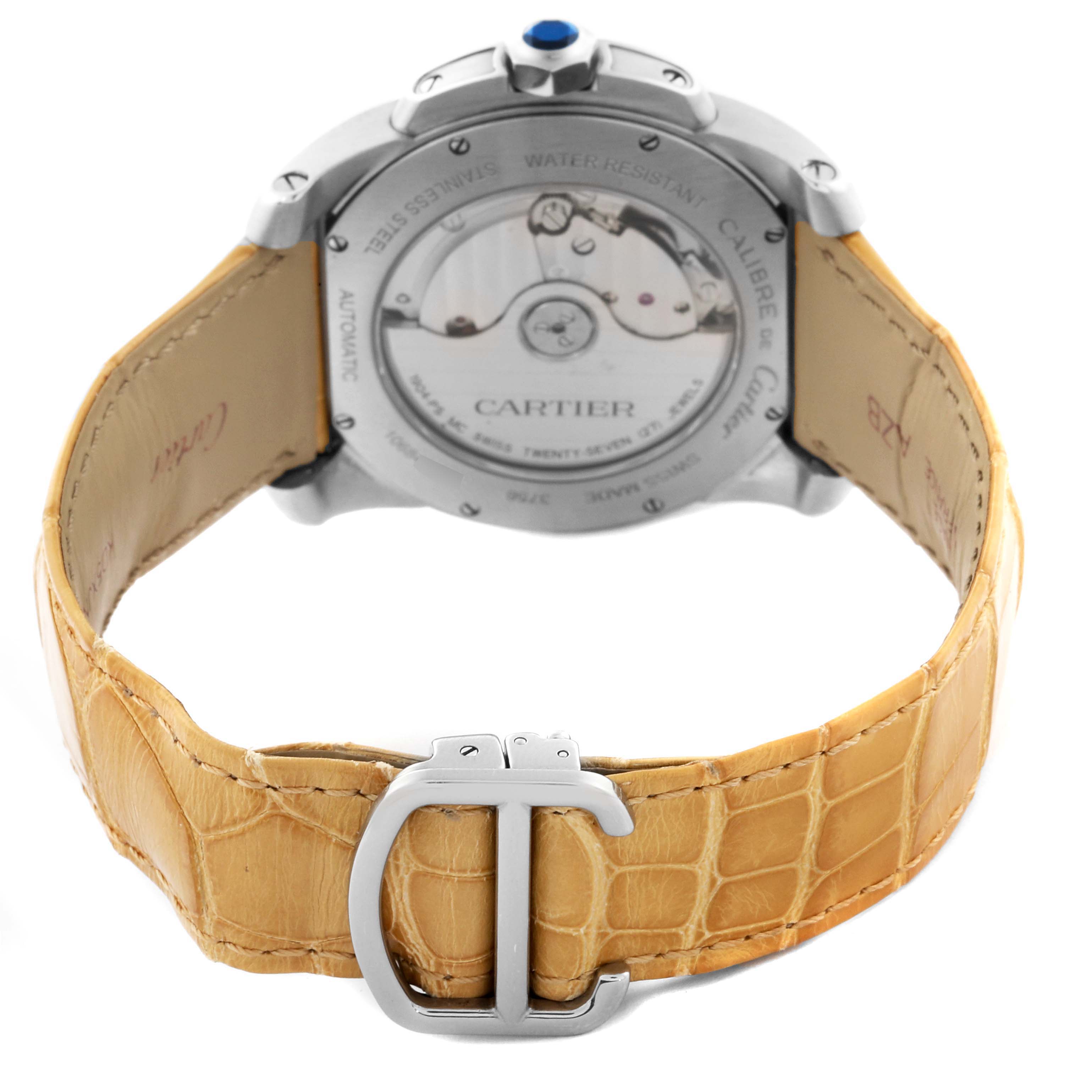 The image shows the back of the Calibre de Cartier watch, highlighting the case back and tan leather strap with buckle.