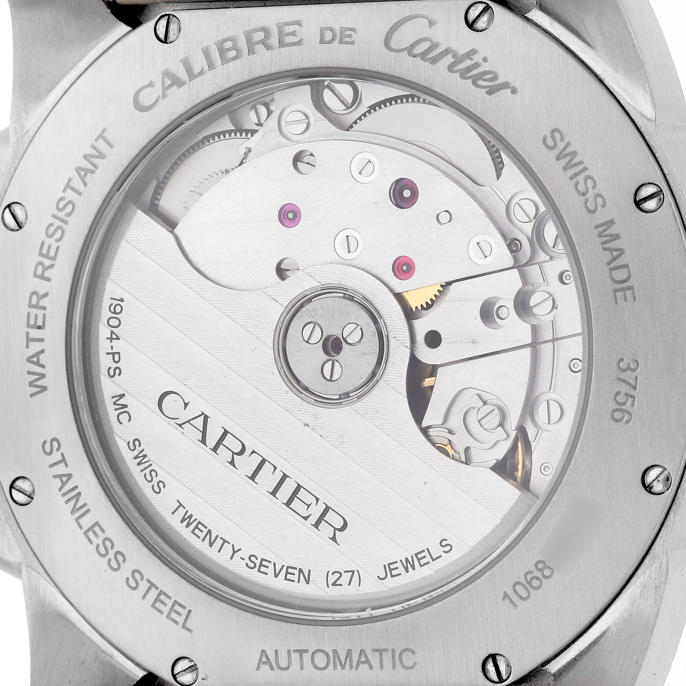 The image shows the case back of the Calibre de Cartier watch, highlighting its automatic movement and internal mechanics.
