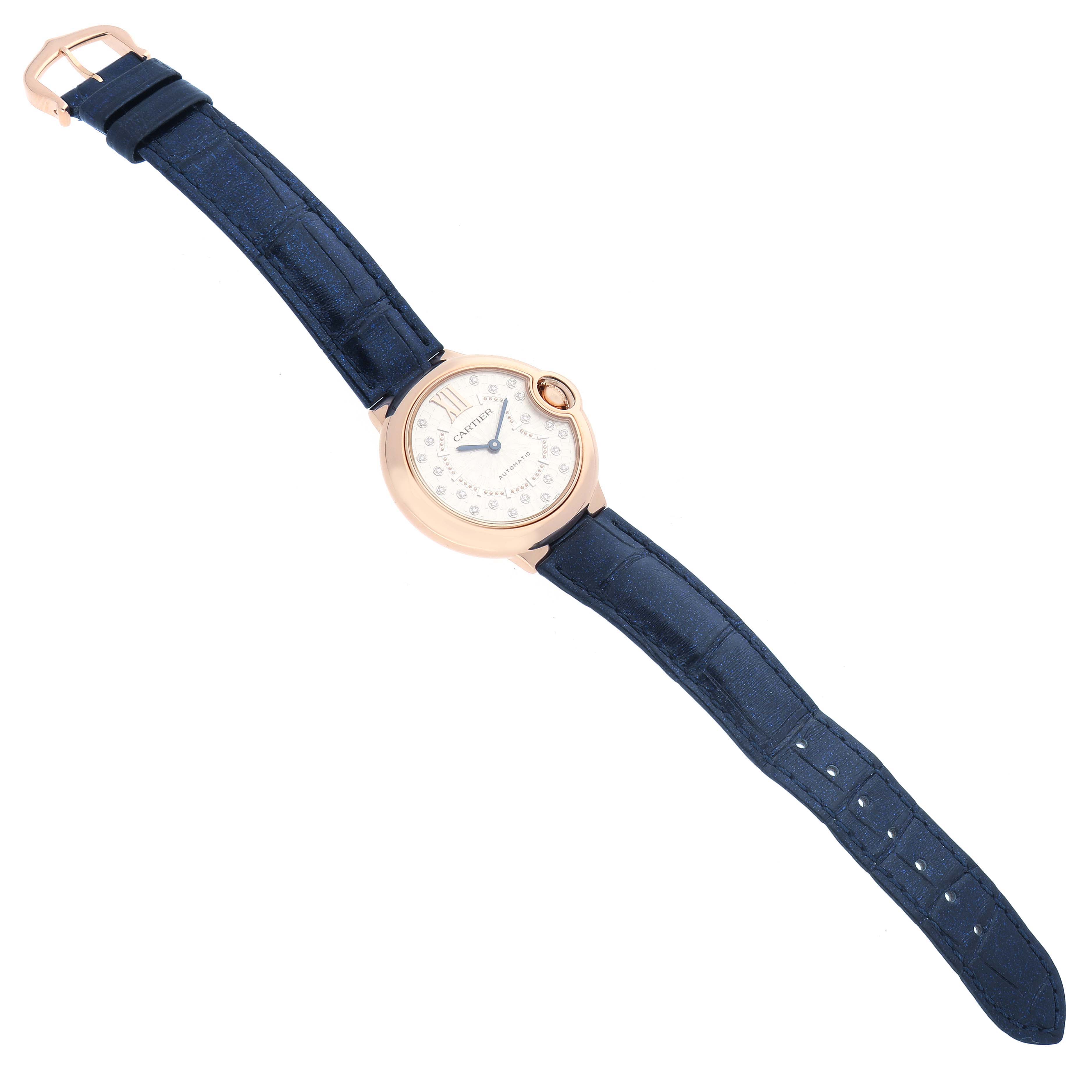 The Cartier Ballon Bleu WGBB0052 Men
s Rose Gold Silver Dial watch is shown from a top-down angle, displaying the face, rose gold case, and blue strap.