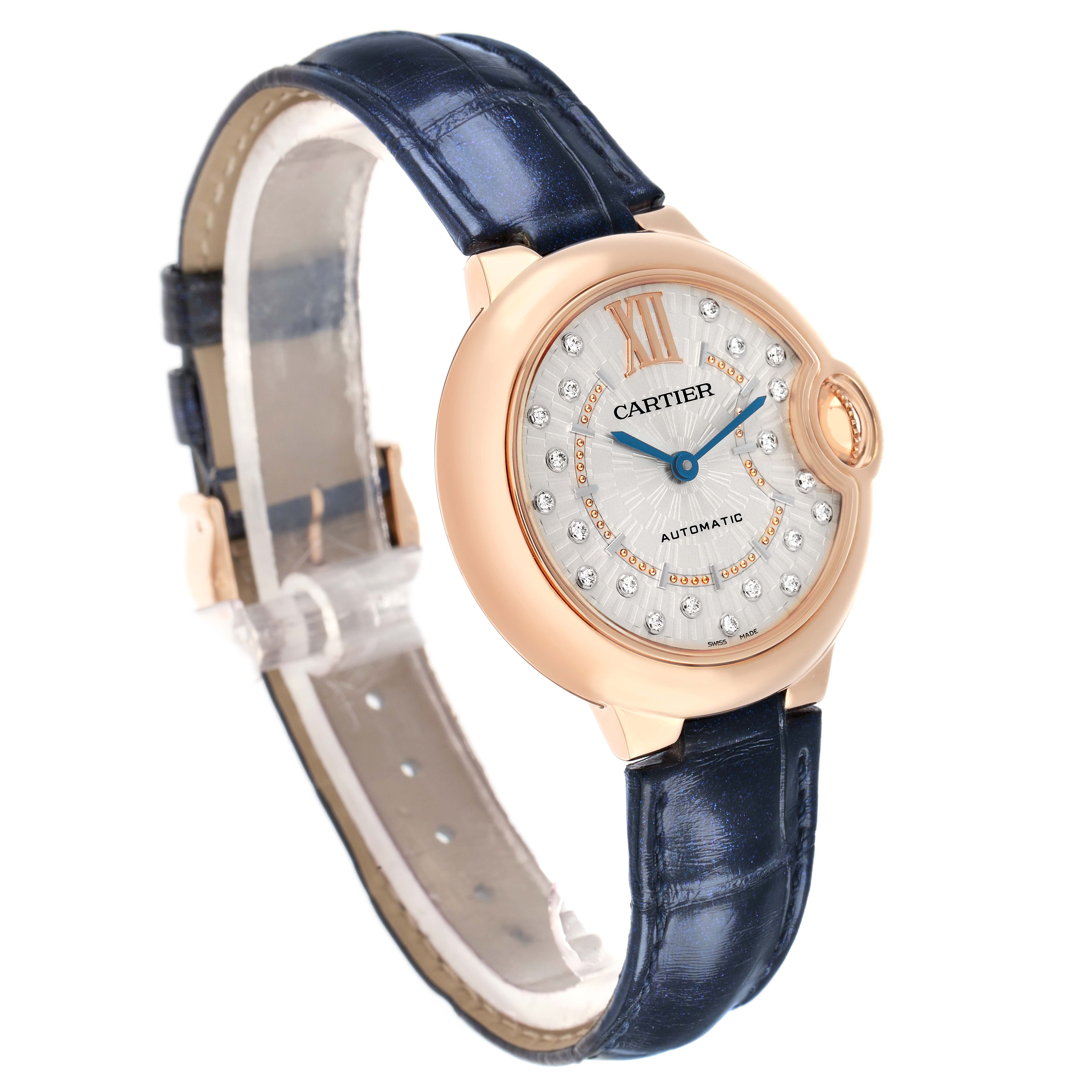 The image shows a Cartier Ballon Bleu WGBB0052 Men
s Rose Gold Silver Dial watch at a three-quarter angle, displaying the face, crown, and blue leather strap.