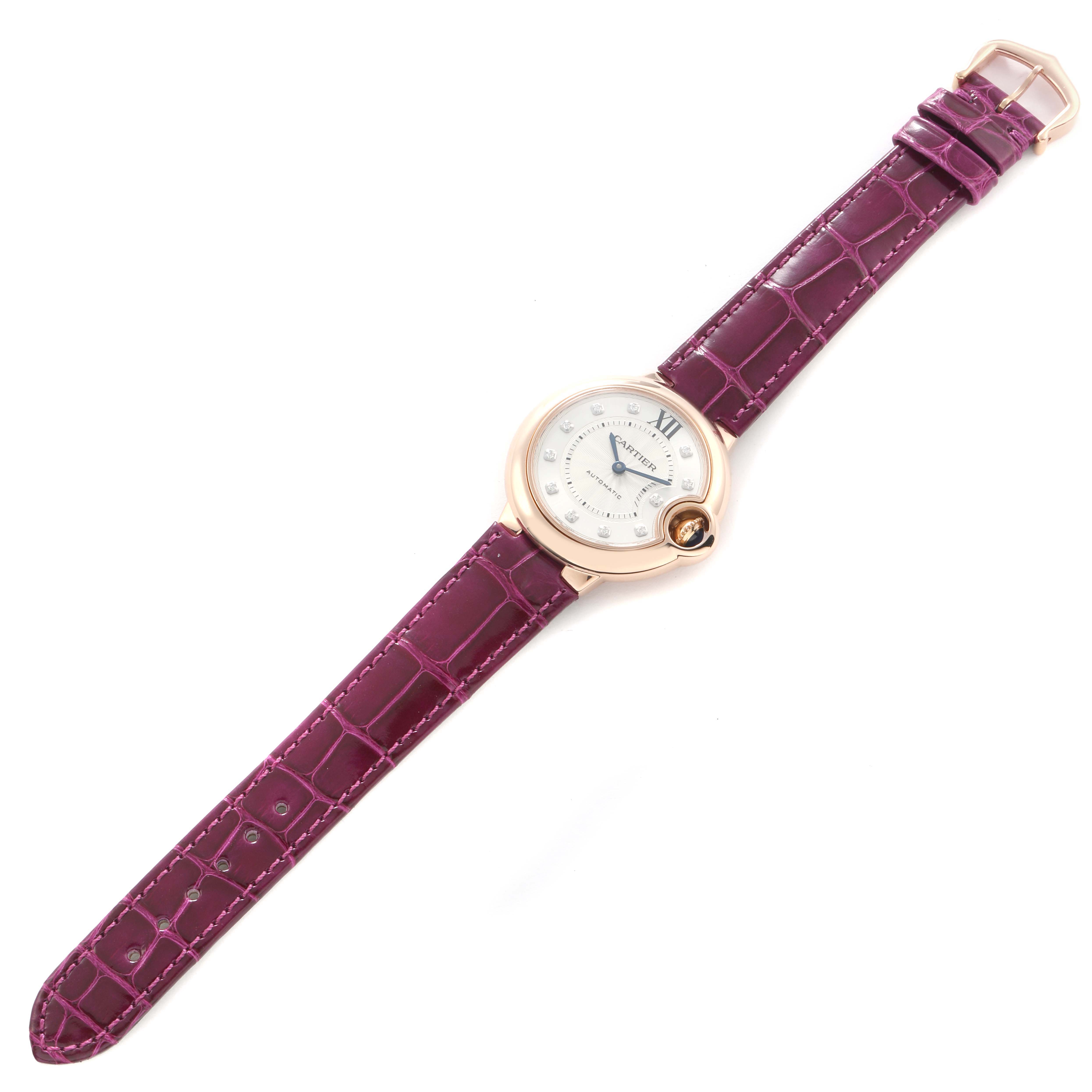 The Cartier Ballon Bleu WE902063 Women
s Rose Gold Silver Dial watch is shown from a top view, displaying its dial, case, and purple leather strap.