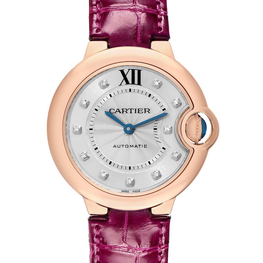 The Cartier Ballon Bleu WE902063 Women's Rose Gold Silver Dial watch is shown from a front angle, featuring its rose gold case, silver dial with diamond markers, and purple leather strap.