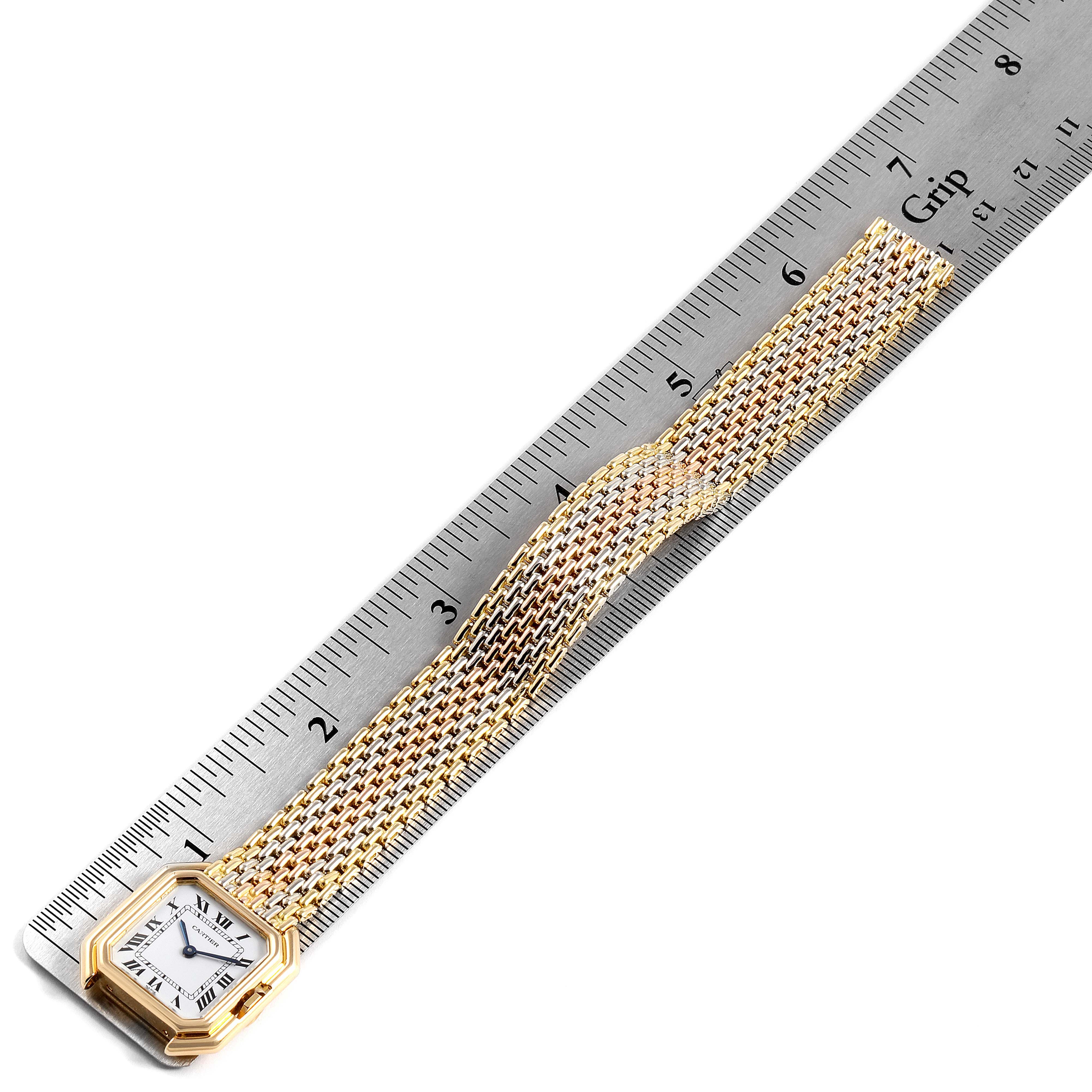 The image shows a Cartier Tank Classic Women's Yellow Gold White Dial Women's Yellow Gold White Dial watch placed against a ruler, displaying the face and gold mesh strap.