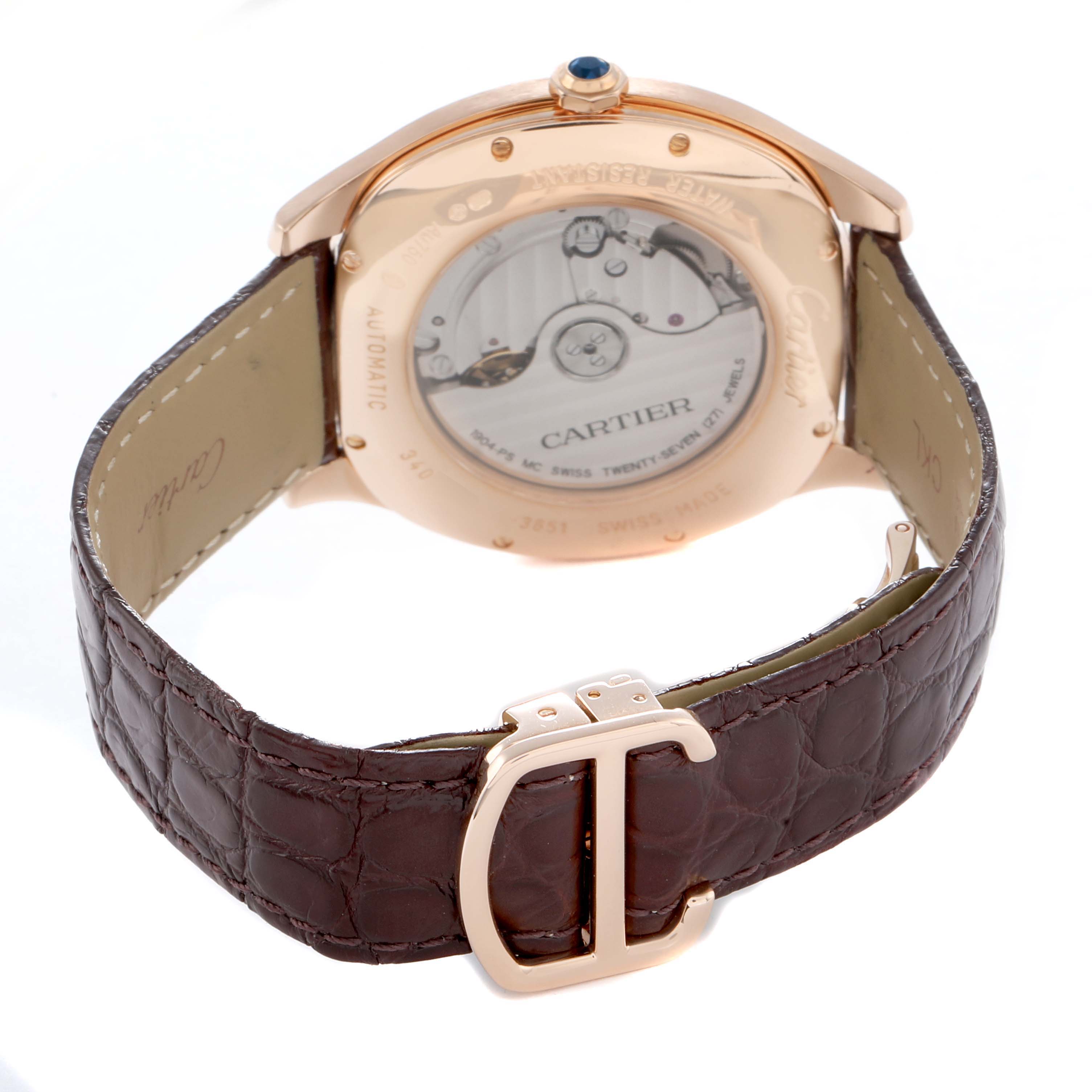 The image shows the back of the Drive de Cartier watch by Cartier, highlighting the automatic mechanism and a leather strap with a "CD" clasp.