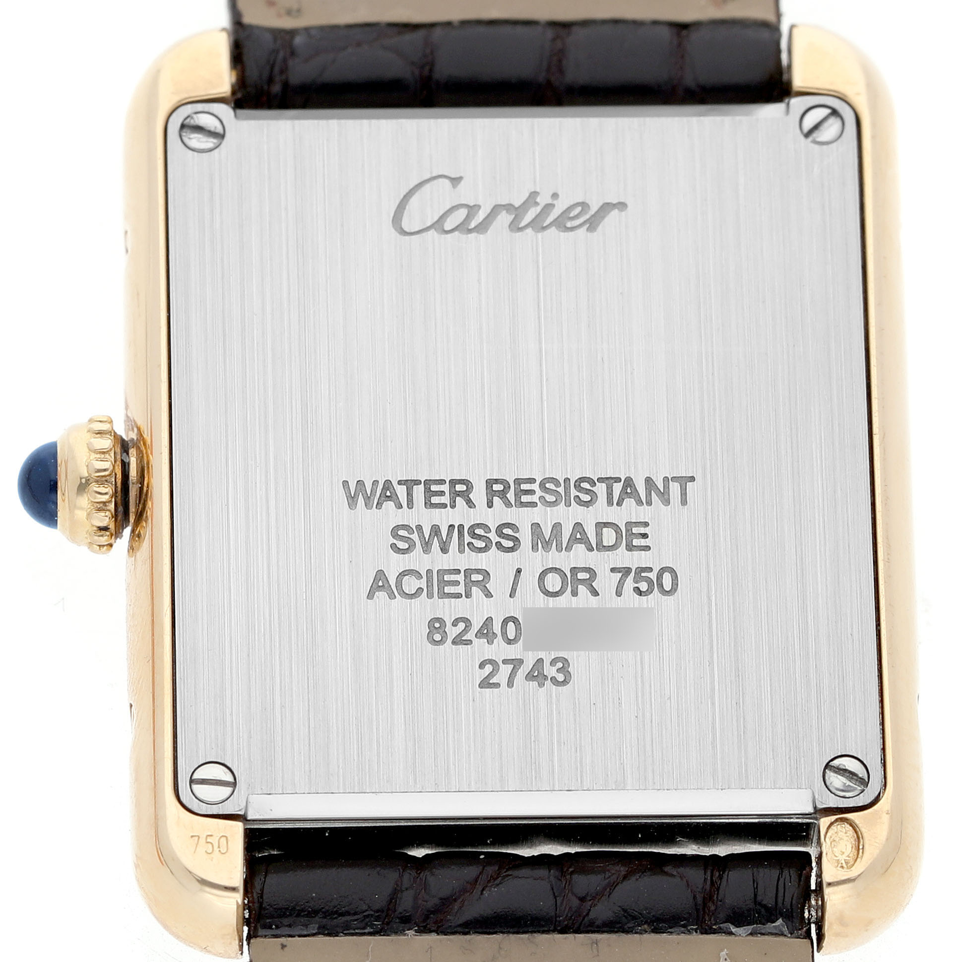 The image shows the backplate of a Cartier Tank Solo W1018755 Women's Yellow Gold Silver Dial watch, highlighting inscriptions and the crown.