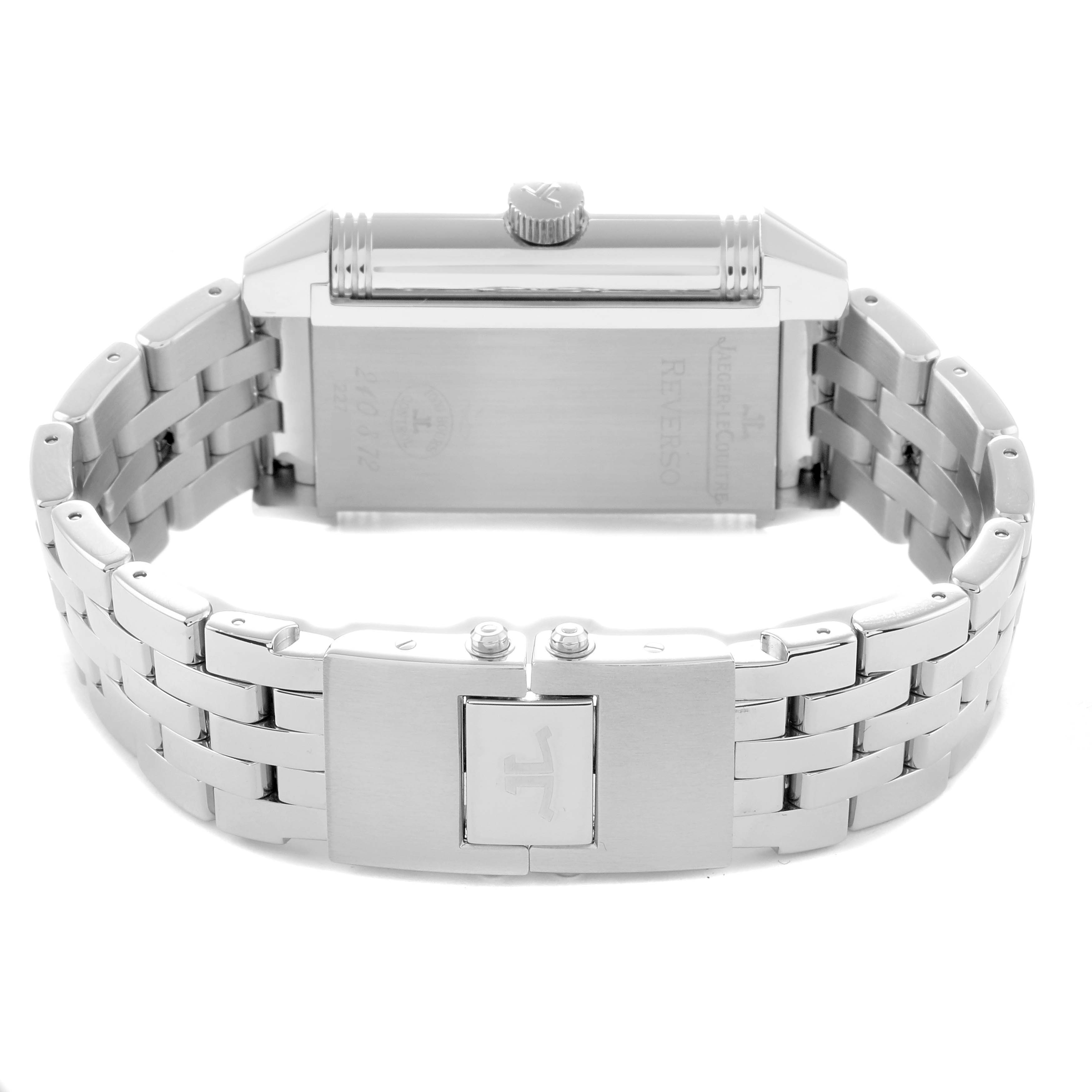The image shows the Jaeger-LeCoultre Reverso watch from a rear angle, highlighting the back case, crown, and metal bracelet.