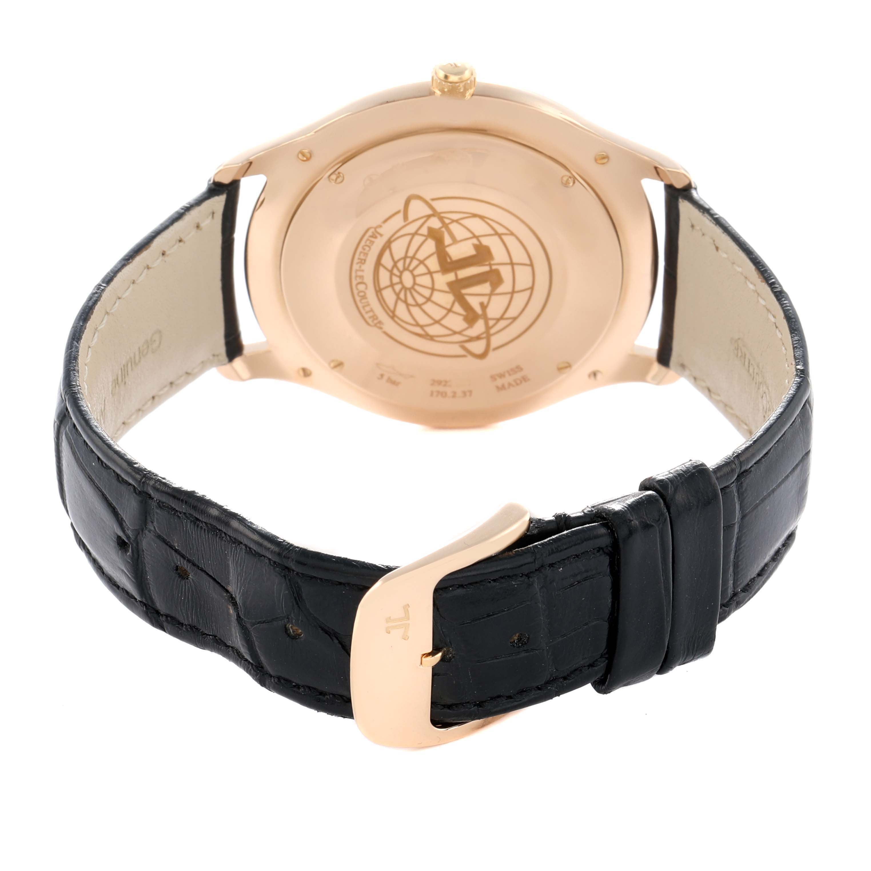 The image shows the back of a Jaeger LeCoultre Master Q1332511 Men
s Rose Gold Beige Dial watch with an engraved case back and a black leather strap.