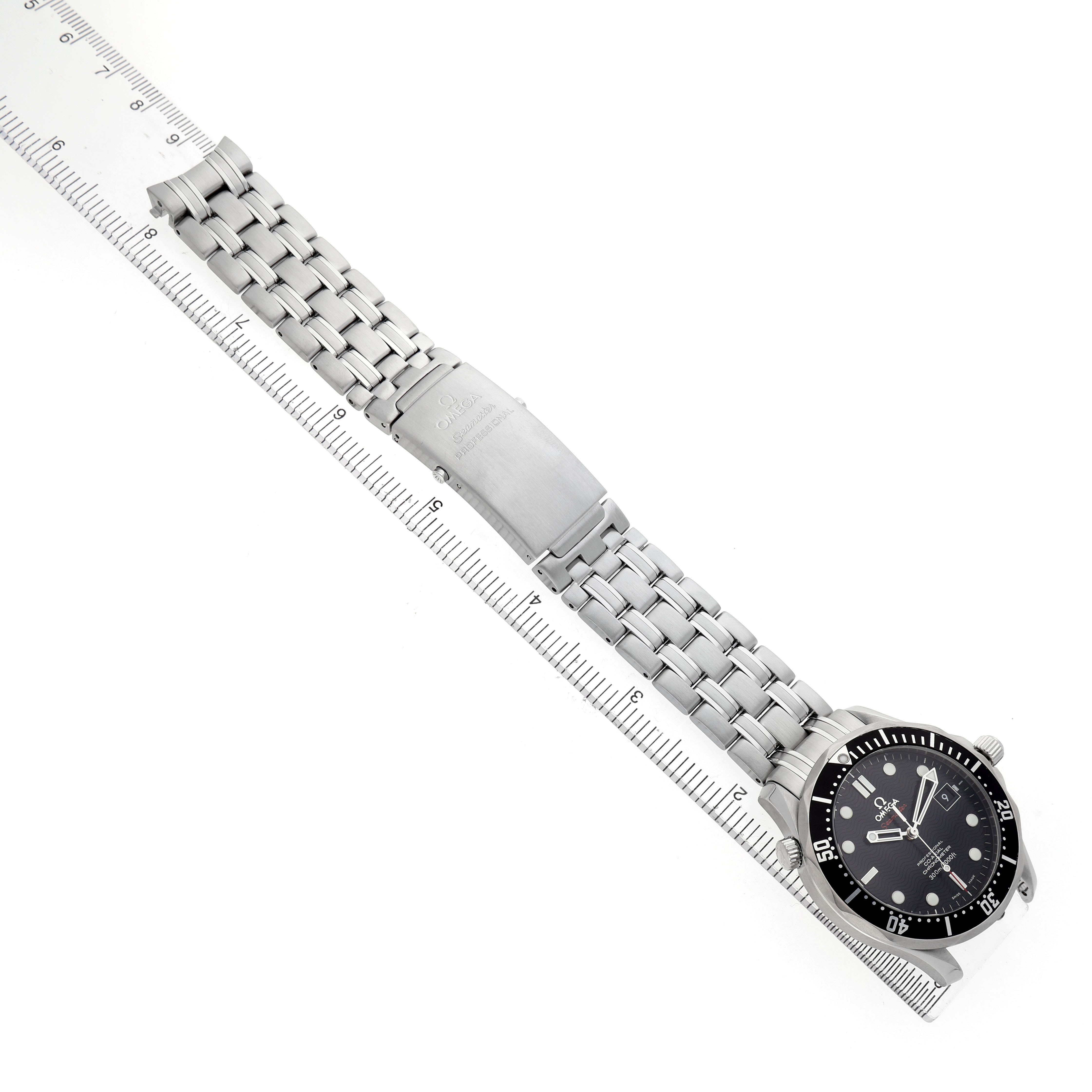 The Omega Seamaster 212.30.41.20.01.002 Men's Stainless Steel Black Dial watch is shown diagonally, displaying the face, case, and full stainless steel bracelet alongside a ruler.