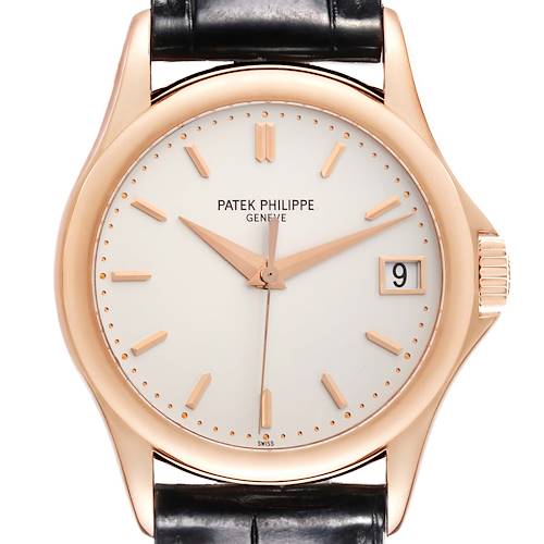 The Patek Philippe Calatrava watch is shown from a front angle, displaying its face, hands, date, and crown.