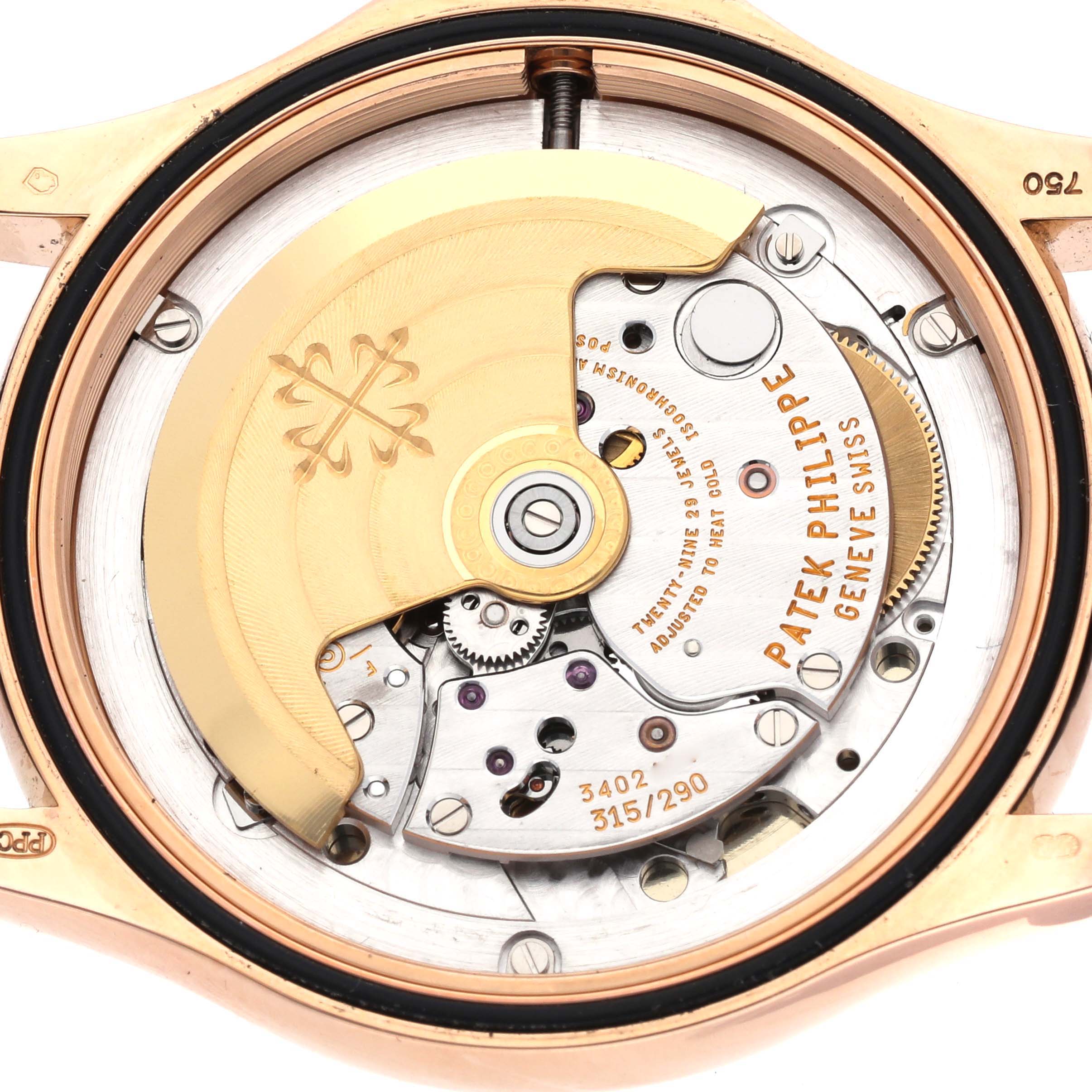 The image shows a close-up view of the Patek Philippe Calatrava 5127R-001 Men's Rose Gold Silver Dial 5127R-001 Men's Rose Gold Silver Dial's movement, highlighting the automatic rotor and intricate mechanics.