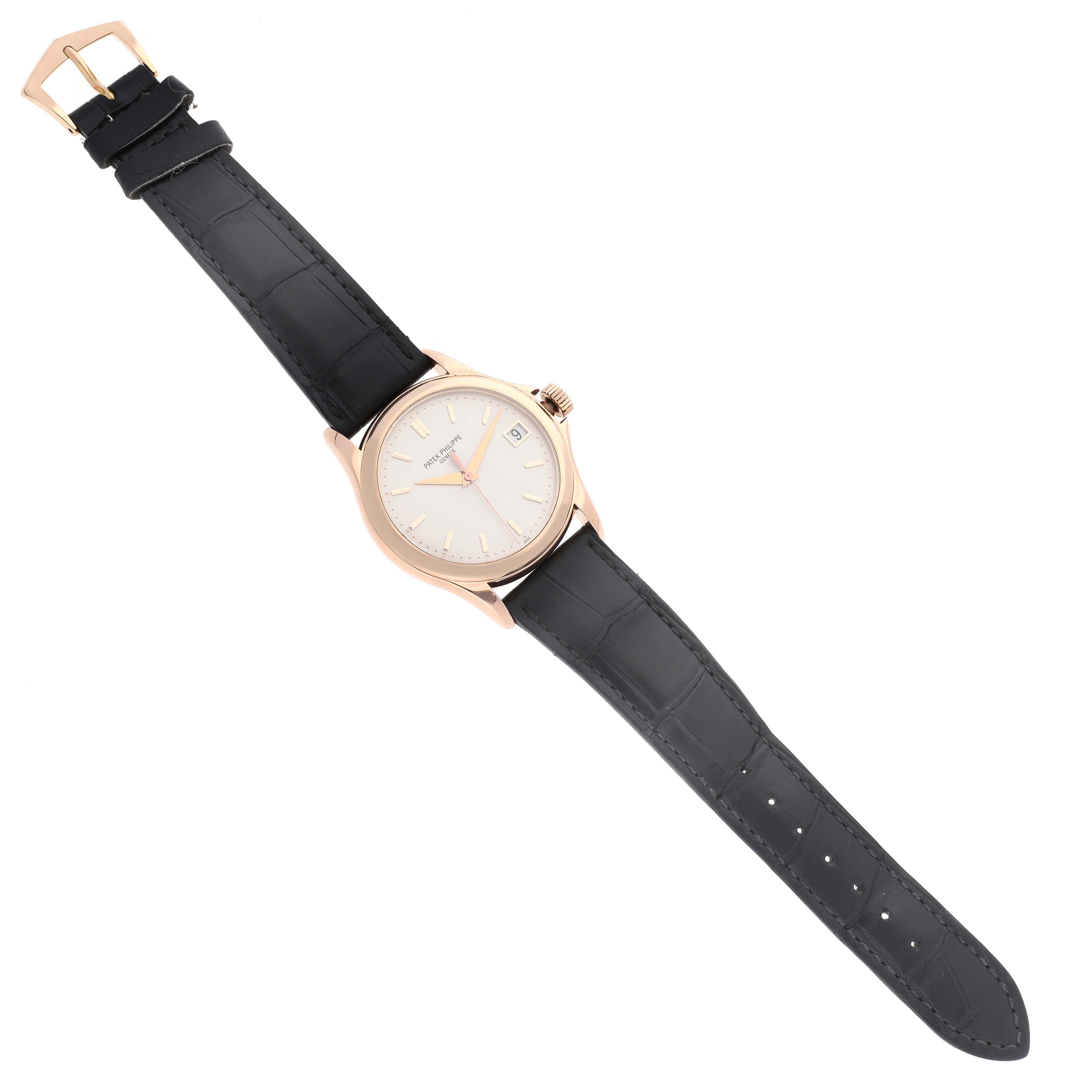 The Patek Philippe Calatrava 5127R-001 Men's Rose Gold Silver Dial 5127R-001 Men's Rose Gold Silver Dial watch is shown from a top-down angle, displaying its face, bezel, and black leather strap.