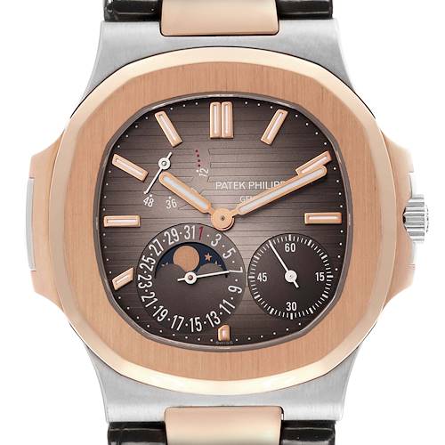 The image shows a front view of the Patek Philippe Nautilus watch, highlighting its dial, subdials, and bezel.