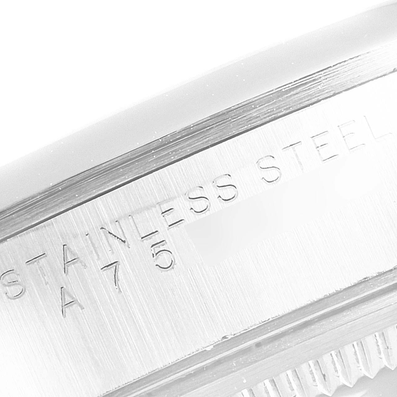 This image shows a close-up of the side engraving on the bezel of a Rolex Air-King 14000 Men's Stainless Steel Pink Dial 14000 Men's Stainless Steel Pink Dial watch, highlighting the "STAINLESS STEEL" text.