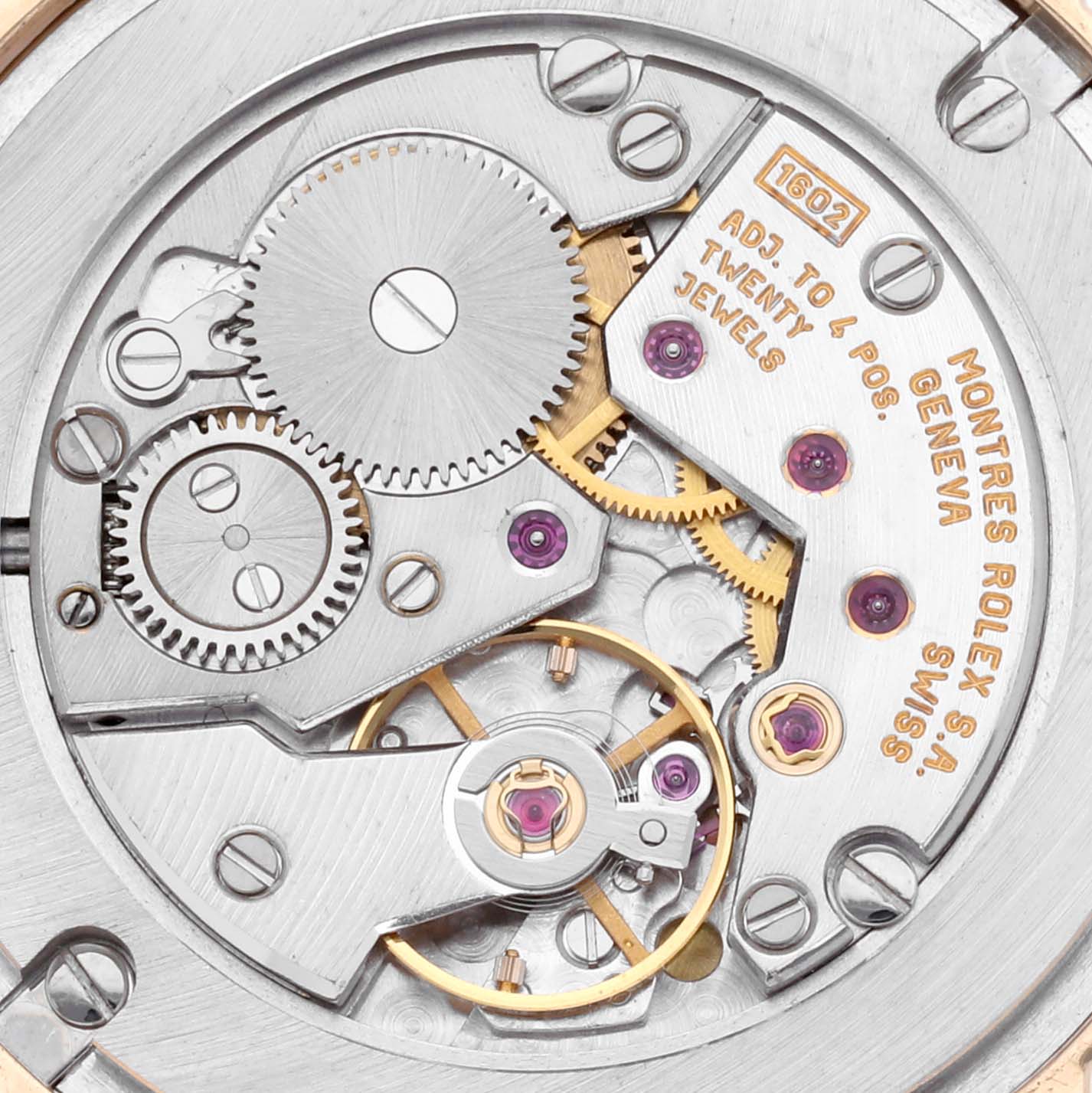The image shows the movement mechanism of a Rolex Cellini 5115 Men's Yellow Gold Silver Dial 5115 Men's Yellow Gold Silver Dial watch, highlighting gears and jewels.