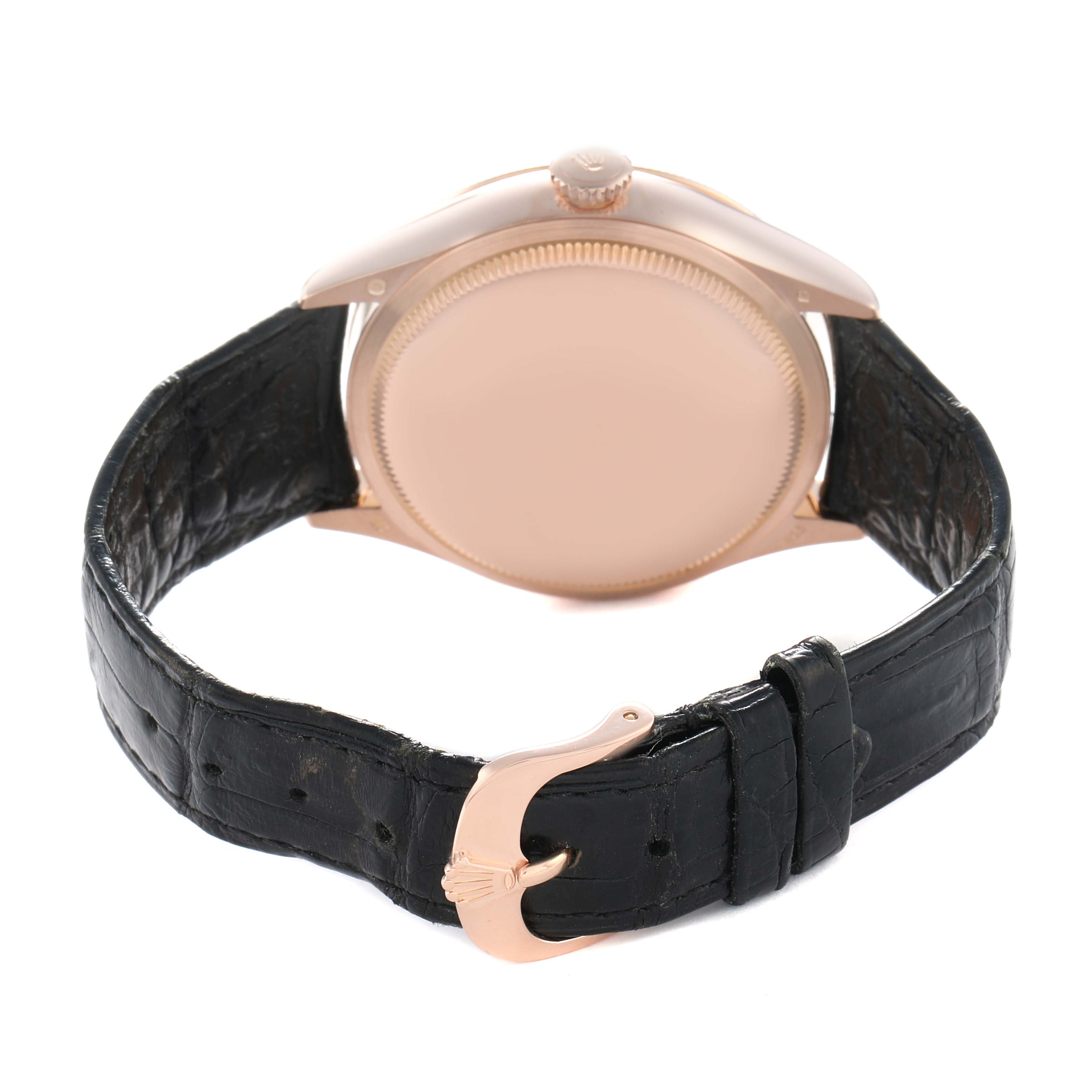 The Rolex Cellini 50515 Men
s Rose Gold Silver Dial watch is shown from the back, highlighting the case, crown, and black leather strap with a clasp.