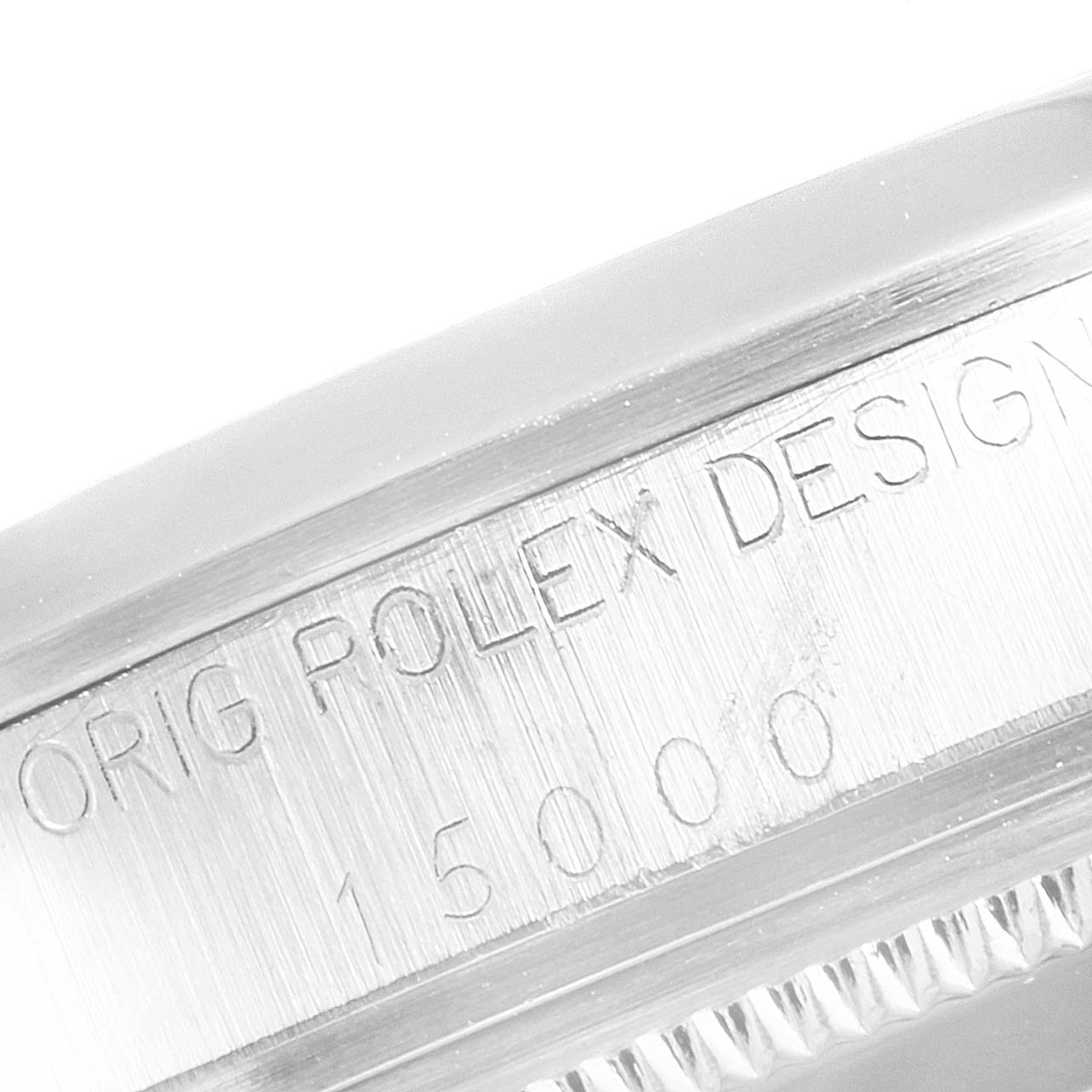 This image shows a close-up of the engraved bezel and side case of the Rolex Vintage Collection 15000 Men's Stainless Steel Silver Dial 15000 Men's Stainless Steel Silver Dial watch.