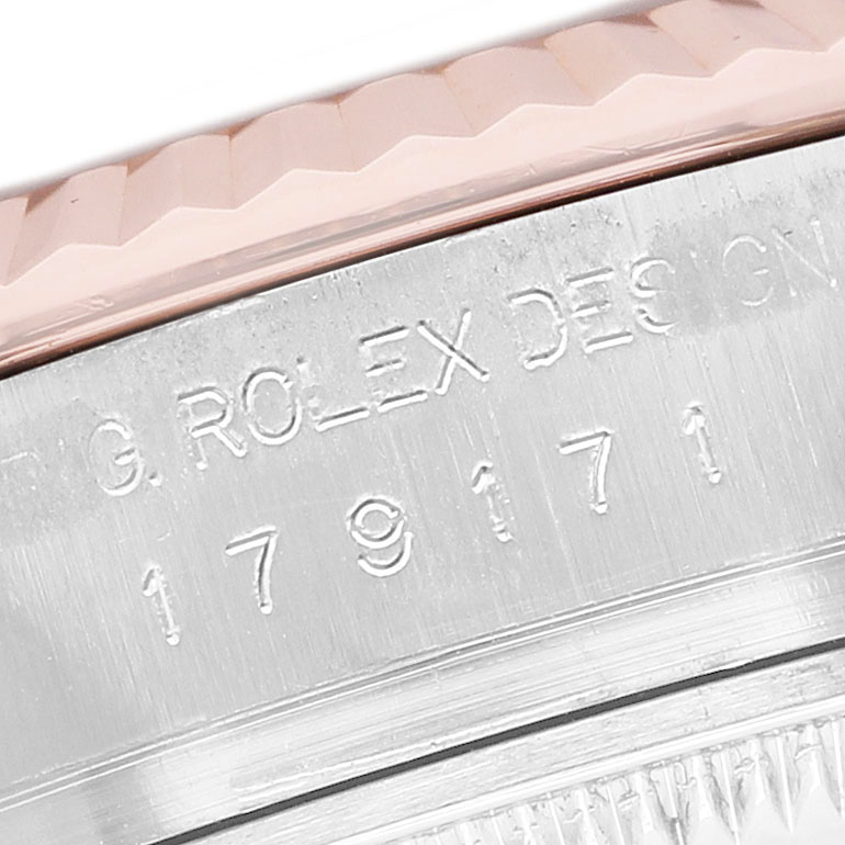 The image shows a close-up of the side of a Rolex Datejust 179171 Women's Steel and Gold (two tone) Silver Dial watch, focusing on the engraved text and bezel.