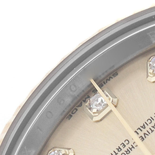 The image shows a close-up of the dial and bezel of a Rolex Datejust 279173 Women's Stainless Steel Champagne Dial, focusing on diamond hour markers and the minute hand.