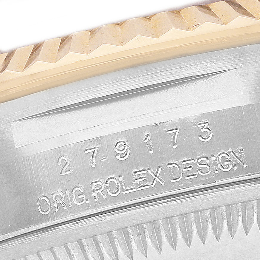 The image shows a close-up of the Rolex Datejust 279173 Women's Steel and Gold (two tone) Purple Dial model's fluted bezel and engraved inner case wall.