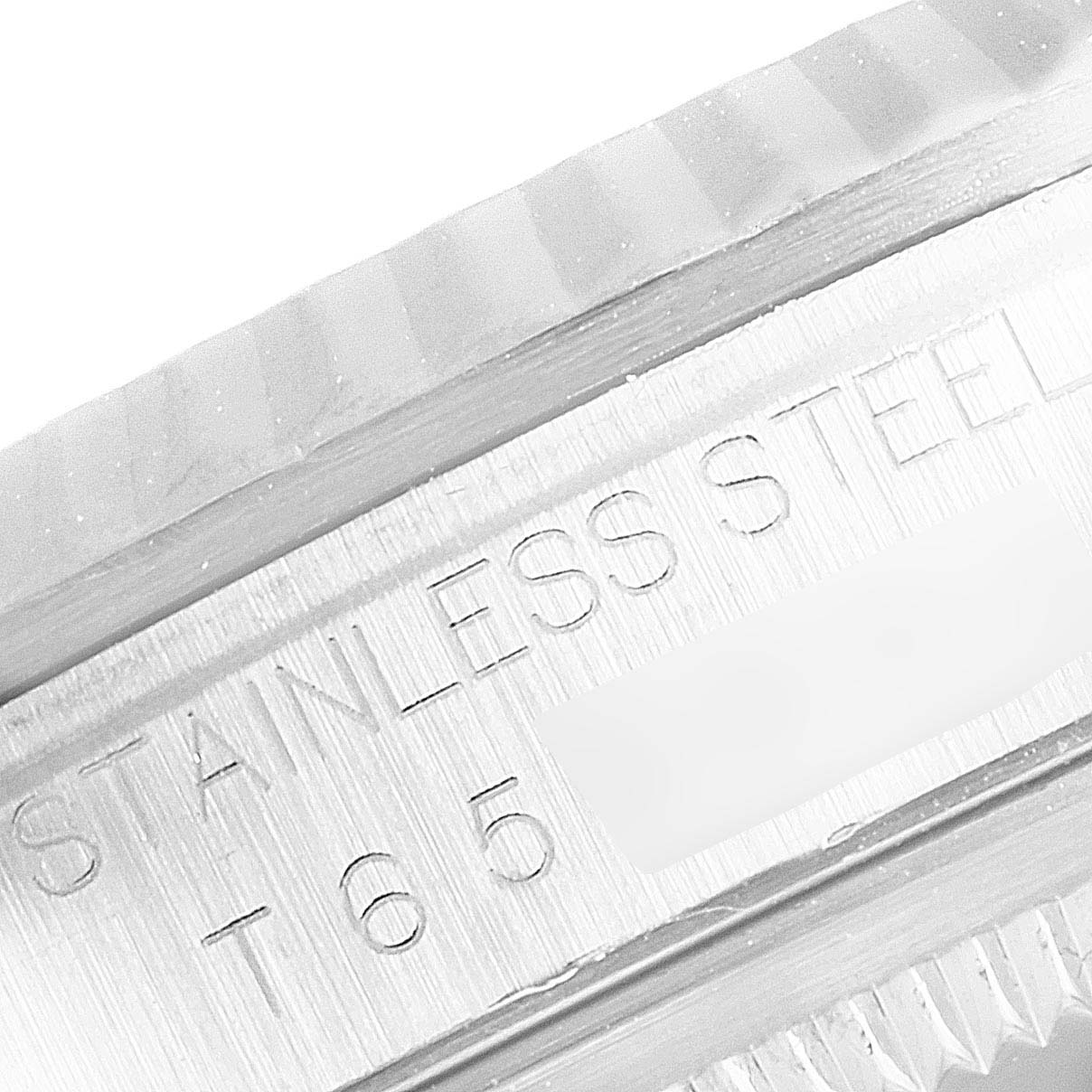 The image shows a close-up of the side of the case and the fluted bezel of a Rolex Datejust 16234 Men's Stainless Steel Pink Dial 16234 Men's Stainless Steel Pink Dial watch, focusing on the "Stainless Steel" engraving.