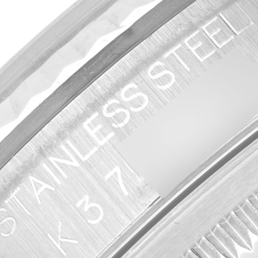 This close-up shows the side engravings on the stainless steel bezel of a Rolex Datejust 16234 Men's Stainless Steel Silver Dial 16234 Men's Stainless Steel Silver Dial.