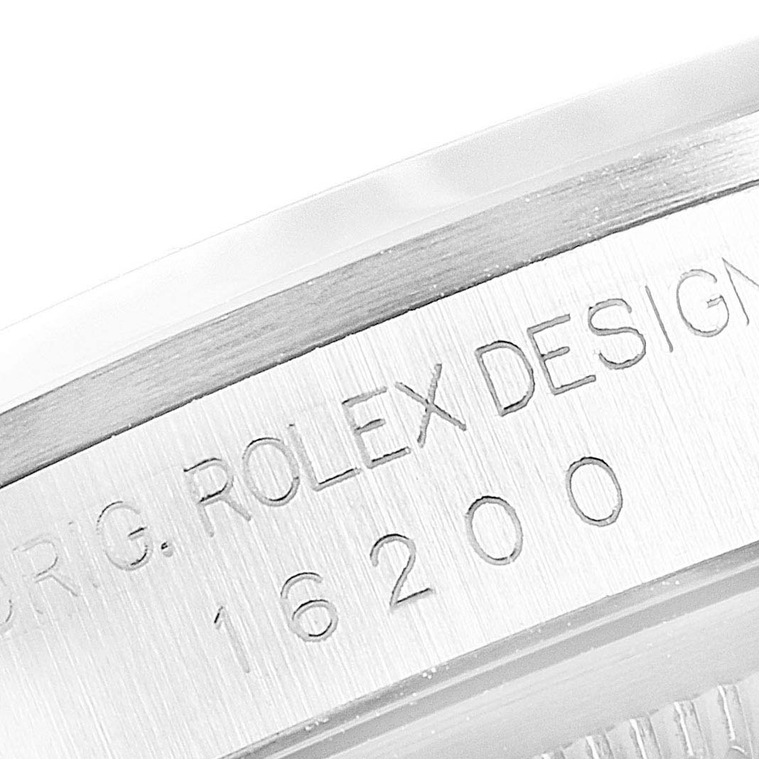 This image shows an angled close-up view of the serial number engraving on a Rolex Datejust 16200 Men's Stainless Steel Black Dial 16200 Men's Stainless Steel Black Dial model.