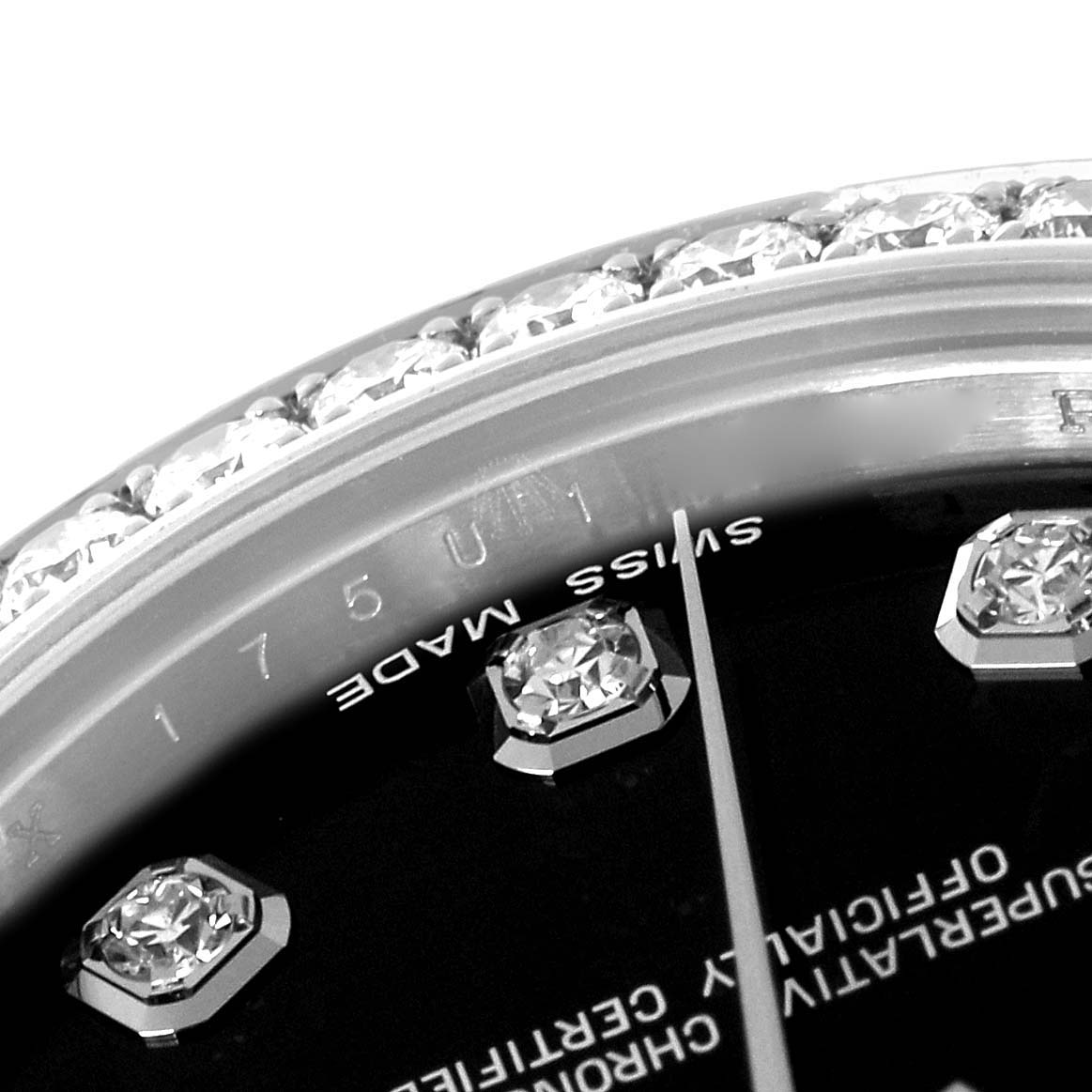 The image shows a close-up of the Rolex Mid-Size 178384 Women's Stainless Steel Black Dial 178384 Women's Stainless Steel Black Dial watch's bezel, dial details, and part of the hands.