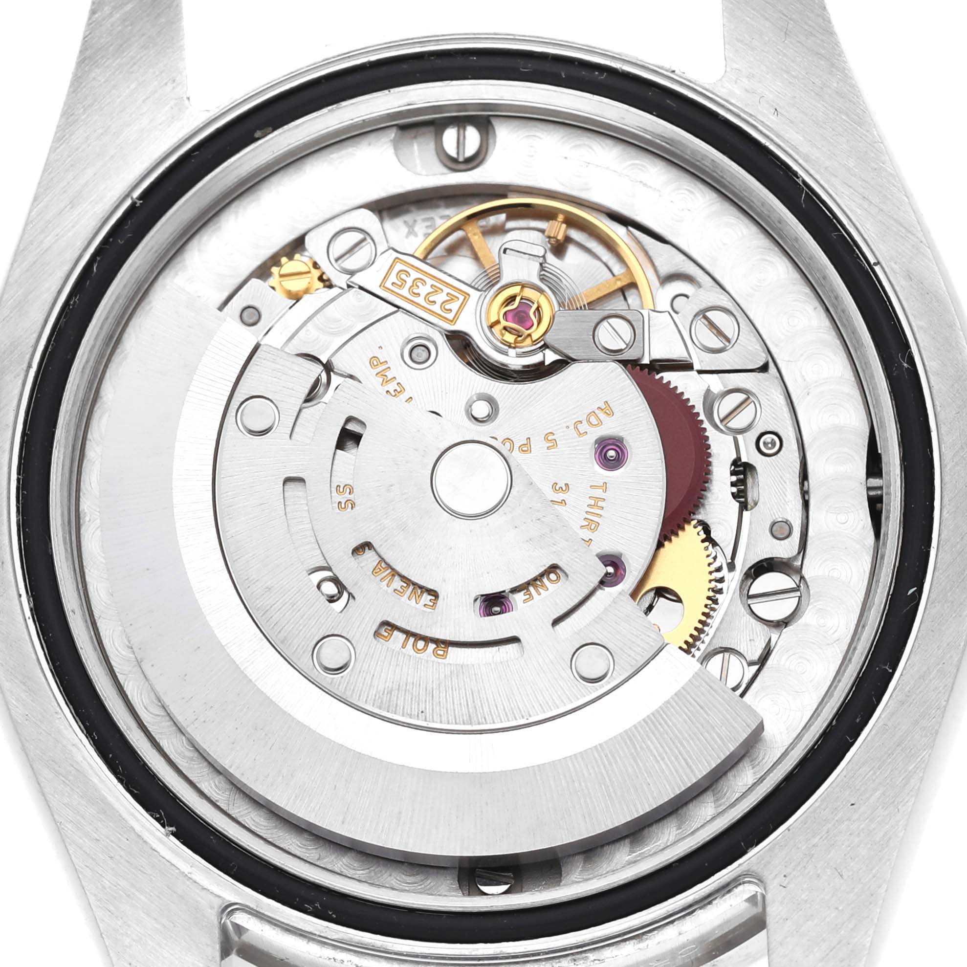 The image shows the movement of a Rolex Mid-Size 178384 Women's Stainless Steel Black Dial 178384 Women's Stainless Steel Black Dial watch from a back view, revealing gears and mechanics.