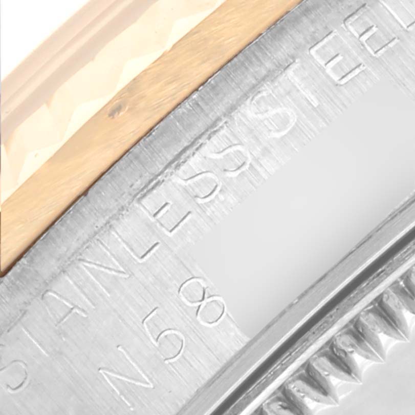 The image shows a close-up of the side of a Rolex Mid-Size 68273 Women's Steel and Gold (two tone) Blue Dial 68273 Women's Steel and Gold (two tone) Blue Dial watch, highlighting the "STAINLESS STEEL" engraving and bezel edge.