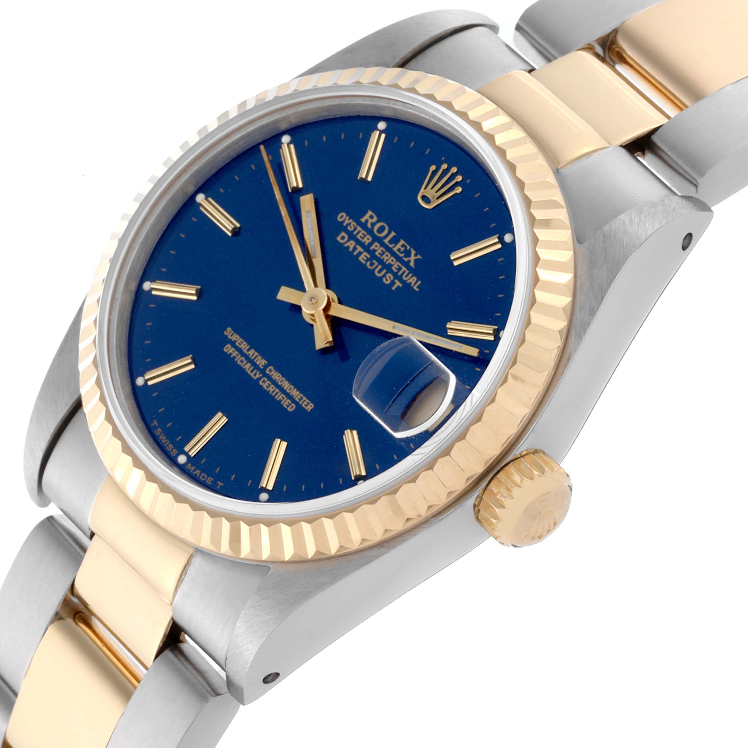 The Rolex Mid-Size 68273 Women's Steel and Gold (two tone) Blue Dial 68273 Women's Steel and Gold (two tone) Blue Dial watch is shown at an oblique angle, highlighting the dial, bezel, crown, and part of the bracelet.