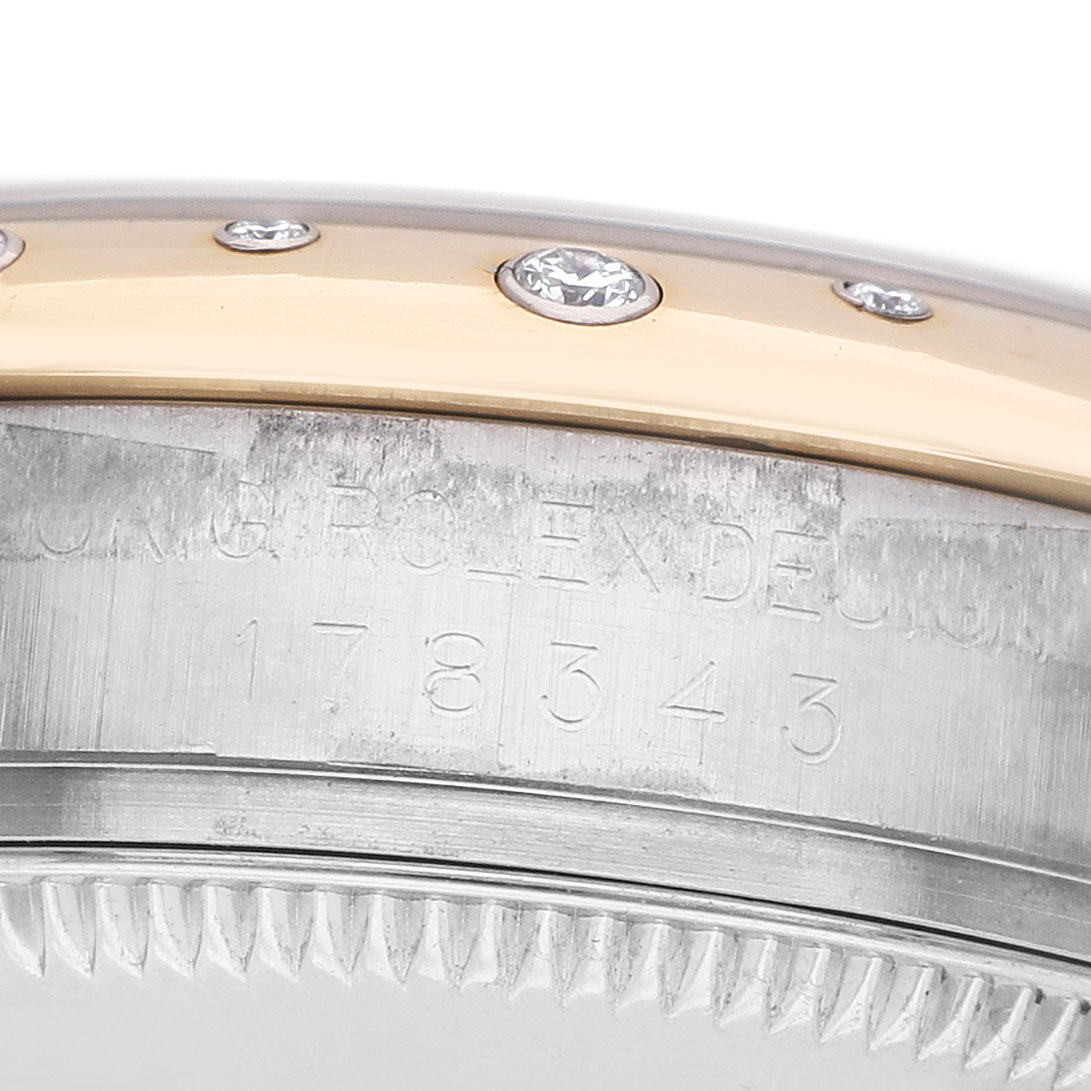 The image shows a close-up of the side of a Rolex Datejust 178343 Women's Steel and Gold (two tone) White Dial, detailing the engraved model number and diamond-set bezel.