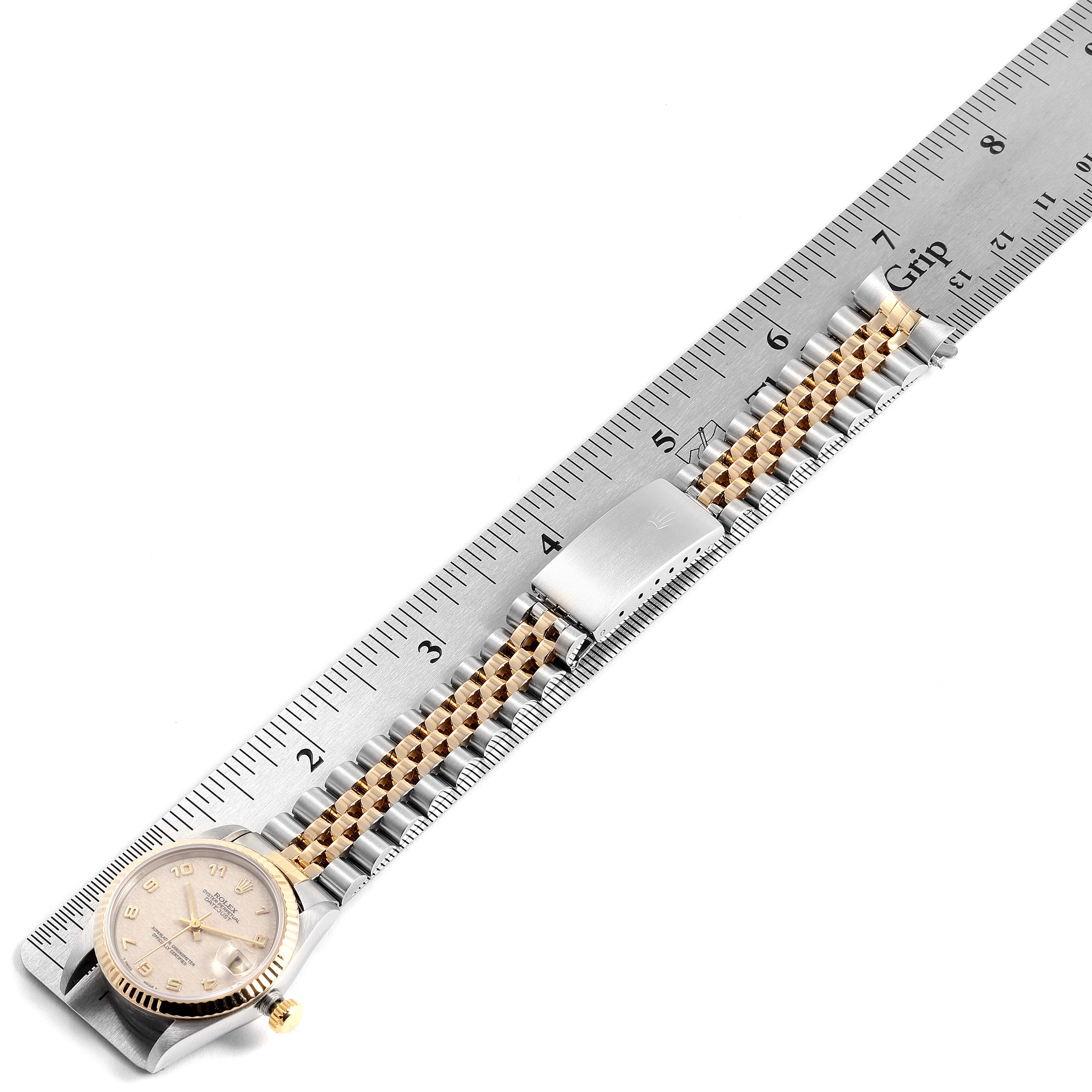 The image shows a Rolex Mid-Size 68273 Women
s Steel and Gold (two tone) Beige Dial 68273 Women
s Steel and Gold (two tone) Beige Dial watch laid flat against a ruler, displaying the watch face and band from a top-down angle.
