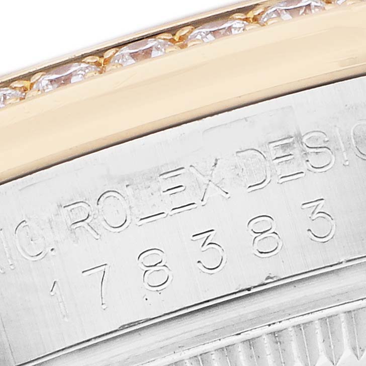 The image shows a close-up of the engraved edge of a Rolex Mid-Size 178383 Women
s Steel and Gold (two tone) Mother of Pearl Dial model, highlighting the serial number and part of the bezel.