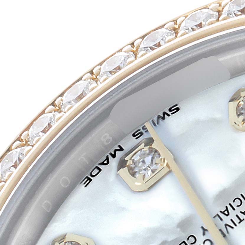 The image shows a close-up of the Rolex Mid-Size 178383 Women
s Steel and Gold (two tone) Mother of Pearl Dial watch dial and diamond bezel from an angled view.
