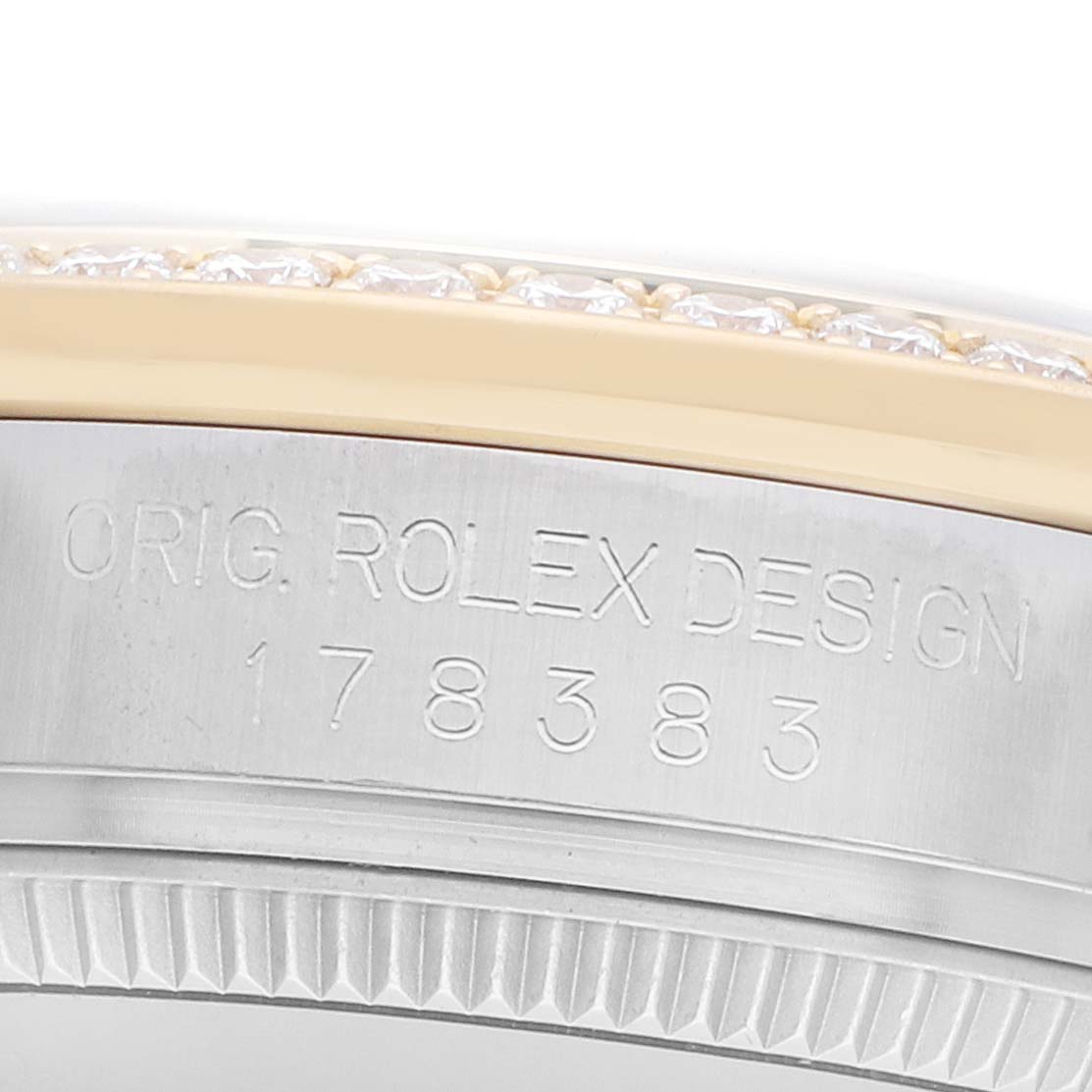 The image shows a close-up of the side of a Rolex Mid-Size 178383 Women
s Steel and Gold (two tone) Silver Dial watch, highlighting its engraved model number and bezel design.