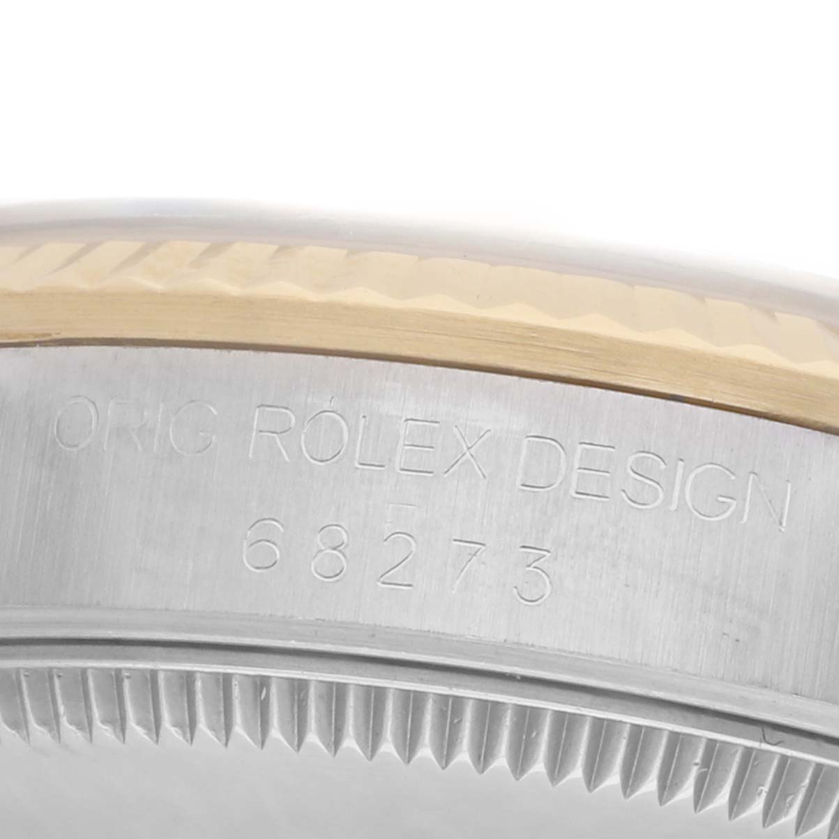 The image shows a close-up side view of the Rolex Datejust 68273 Women
s Steel and Gold (two tone) Champagne Dial watch case and engraving details.