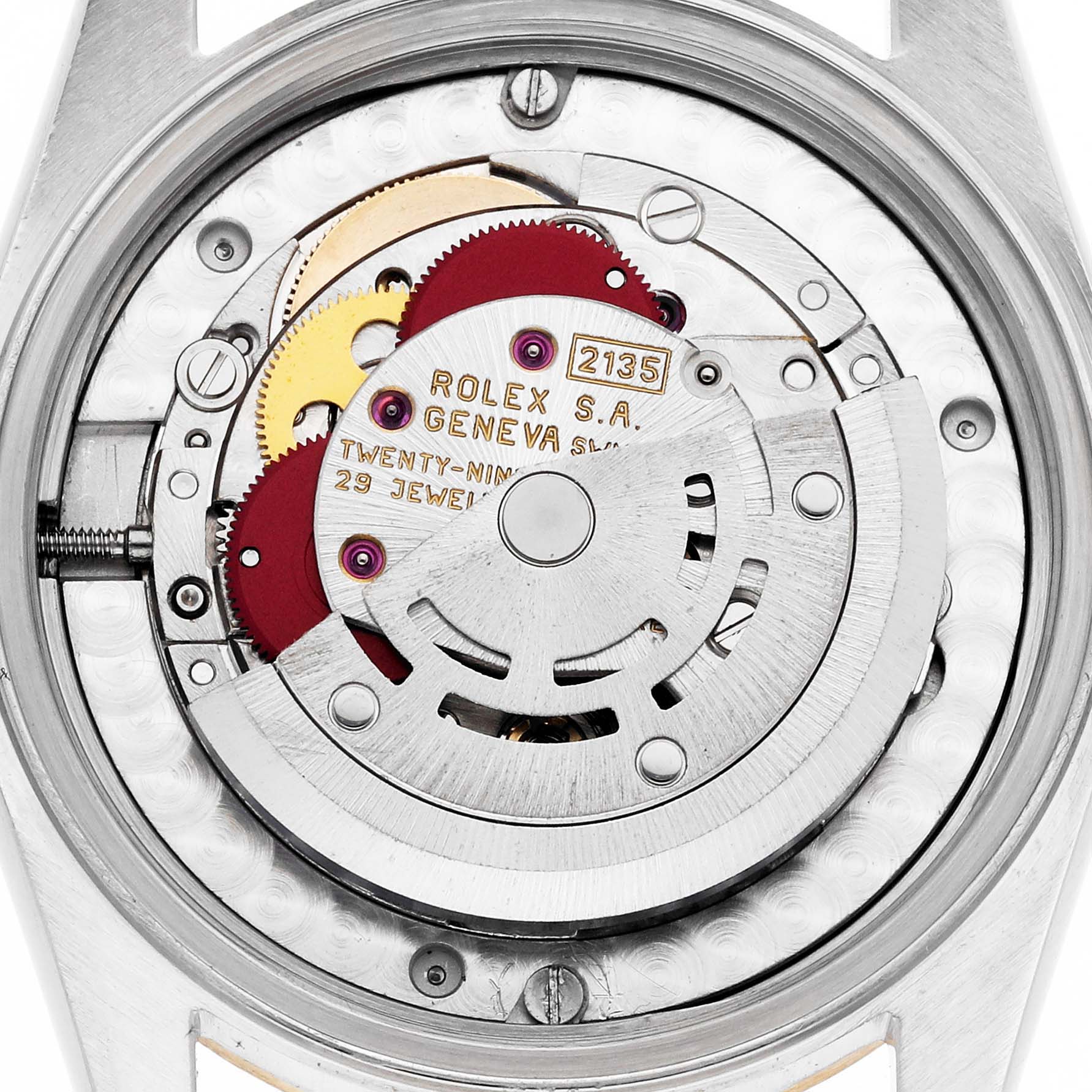 The image shows the movement of a Rolex Mid-Size 68273 Women
s Steel and Gold (two tone) Black Dial watch, focusing on the internal mechanisms and rotor.