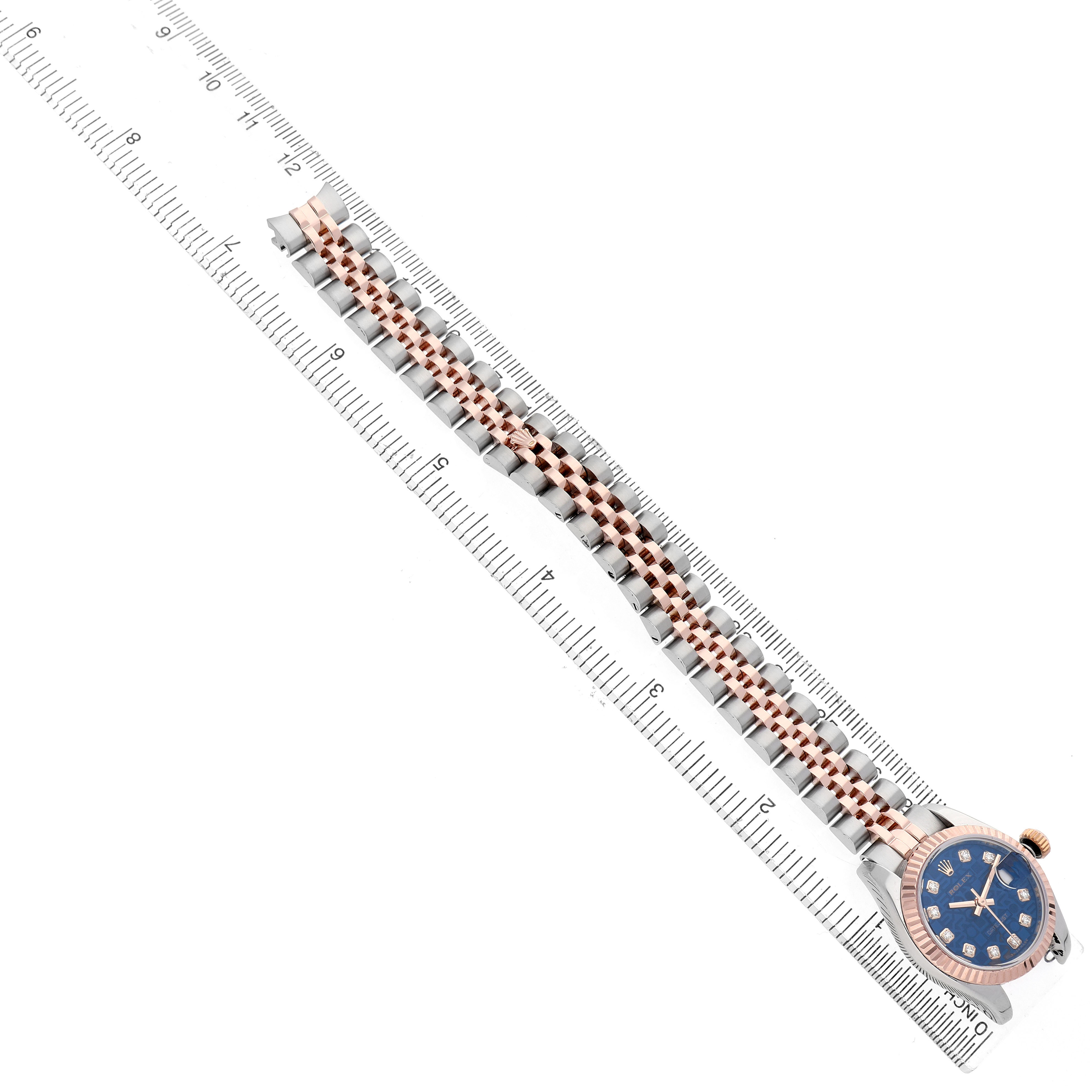 The image shows a top-down view of a Rolex Datejust 179171 Women's Steel and Gold (two tone) Blue Dial watch, with a focus on its bracelet and dial next to a ruler.
